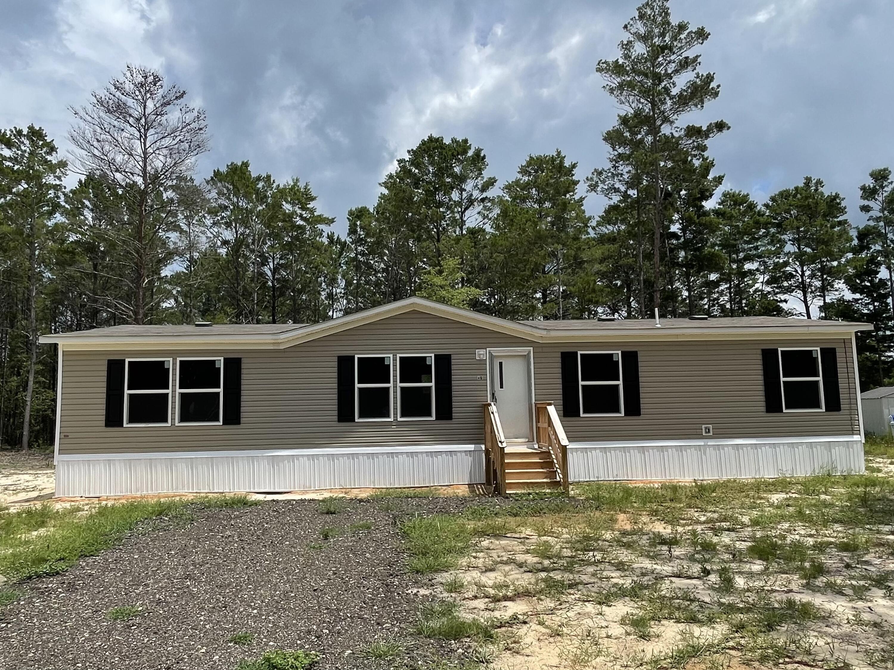 **Seller will provide a $5,000 credit to the buyer to be used for interest rate reduction or closing costs**. This Brand NEW 4-bedroom, 2-bathroom home is almost MOVE IN READY. It's open floor plan has wall to wall vinyl flooring throughout. This home is ENERGY EFFICIENT with OSB Wrap - House Wrap, Lux Low E Thermo-Pane windows that fold down for easy cleaning & maintenance. The kitchen features a large island with underneath storage and plenty of cabinets. Off the kitchen is a large laundry room with wire shelving and to the other side of the kitchen is a flex space that could be used for a den or a dining room area. The master bathroom has a walk-in closet. It also offers a shower/tub combo insert and a spacious countertop. This is a split floor plan home and the opposite side of the