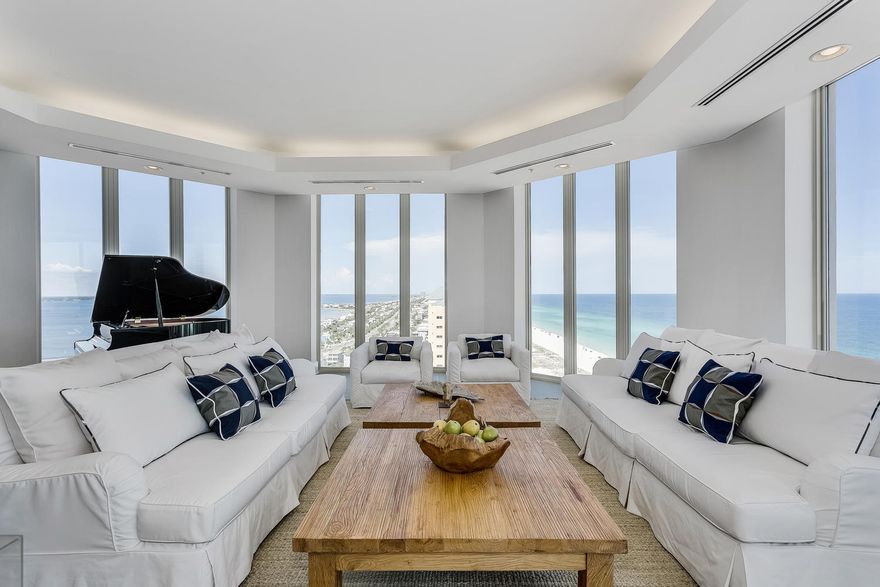 This Beach Club gulf-front sky home offers sweeping views of Pensacola Beach from the beautiful Gulf waters to the Inter-coastal Waterway and the Bay beyond. This four bedroom, four and a half bath home is elegantly furnished and includes a baby grand piano. The balconies are over sized to provide ample outdoor living spaces with views of the Gulf, an eastern view towards Navarre Beach and the back balcony faces northward allowing view of the sound and a westerly view of the beach. The gulf front balcony includes an electric grill and glass railings. Additional features in the condo include floor to ceiling windows with electric solar shades, spacious living area with LED recessed lighting, gourmet kitchen with expansive marble counter space, custom cabinets, a walk-in butler's pantry, and
