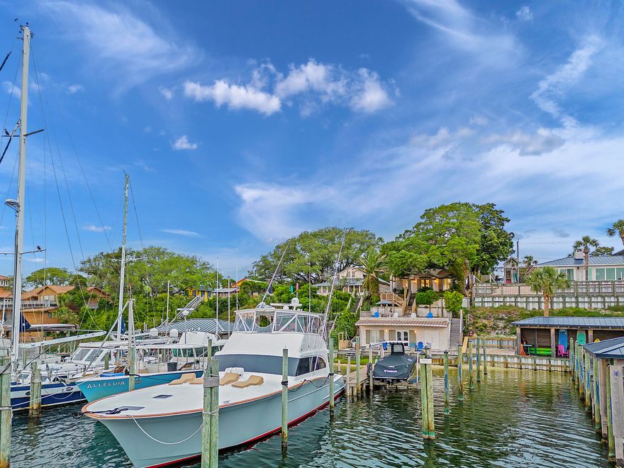 Inspired by the dwellings of the French Riviera and Costa del Sol, this custom built waterfront home on the Destin Harbor was designed for the discerning buyer. The fortified ICF concrete construction is prominently positioned above the Harbor providing beautiful southerly views towards Destin's East Pass. The antique doors on the main level are reminiscent of 16th Century Renaissance architecture of the Tuscan countryside. Complimenting the doors are reclaimed barn wood floors from TN and accompanying wood beams in the ceiling, topped off with a tongue and groove accented ceiling in the living room. Custom designed stair railings, solid wood doors, and various areas of beautiful tile top off some additional architectural features. Flowing outside the main living level is a stunning