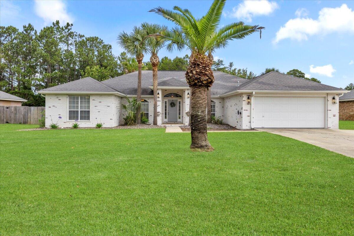 Elegantly Reimagined Whitworth Home in Holley by the Sea!Discover unparalleled craftsmanship in this completely transformed 4-bedroom, 2-bathroom haven nestled in the desirable Holley by the Sea community of Navarre. This former Whitworth Builders home has been meticulously redesigned with premium finishes and thoughtful details throughout.Step inside to find gorgeous hand-scraped engineered hardwood floors complemented by substantial 6'' solid wood baseboards and elegant crown molding. The cohesive aesthetic continues with extensive solid wood trim around every window and door.The gourmet kitchen is a chef's dream, featuring custom cabinetry with ingenious built-ins including spice racks, utensil holders, sheet pan organizers, and a dedicated plate drawer. Prepare meals on beautiful dolomite countertops with upgraded edging while enjoying the convenience of the slightly elevated prep area with sink. The spectacular 12'??5' island creates a natural gathering space, while a pot filler and premium Kitchen Aid appliances elevate the cooking experience.
Organization enthusiasts will appreciate the custom shelving pantry with glass doors, perfect as a bar, appliance garage, library, or display case for collections. Enjoy the charming distinction of both a "he/she pantry" for showcasing heirlooms and pretty things, plus a practical pantry for everyday essentials.
The thoughtfully designed primary suite offers an insulated wall for privacy and a stunning bathroom with a generous two-sink vanity, separate his-and-her closets, a walk-in tiled shower with two shower heads, and tiled floors.
Stylish sliding barn doors and real wood shiplap accent walls add character and warmth throughout the home.
Additional highlights include an oversized utility room with extensive cabinet storage ideal for crafting and floor-to-ceiling custom storage solutions. Practical upgrades like extensive recessed lighting in all spaces (including closets) and a gas water heater enhance daily living.
The outdoor oasis features an oblique-shaped saltwater gunite pool with a waterfall feature and a covered screened porch perfect for year-round enjoyment. The 20'??16' workshop with electric and granite-topped cabinetry provides abundant space for projects, while the finished garage with recessed lighting and hardwood trim offers a polished welcome home.
This exceptional property represents the pinnacle of Florida coastal living in the sought-after Holley by the Sea community. Underground utilities, including sewer on gravity, make this home one of a kind. Schedule your private showing today.
The HBTS community facilities include:
Clay Tennis Courts
*New* Pickle Ball Court
Beach House (Event Hall)
Fishing Pier
Duck Pond
Shallow Boat Launch off East Bay
RV and Tent Campground with 10 RV Back-Ins and 6 Tent Sites
Lap Pool
Family Pool
Baby Pool
Full Weight Room and Cardio Center
Steam Room
Volleyball Court
Ball Field
Basketball Court
Youth Department offering Before and After School Care and Summer Camp