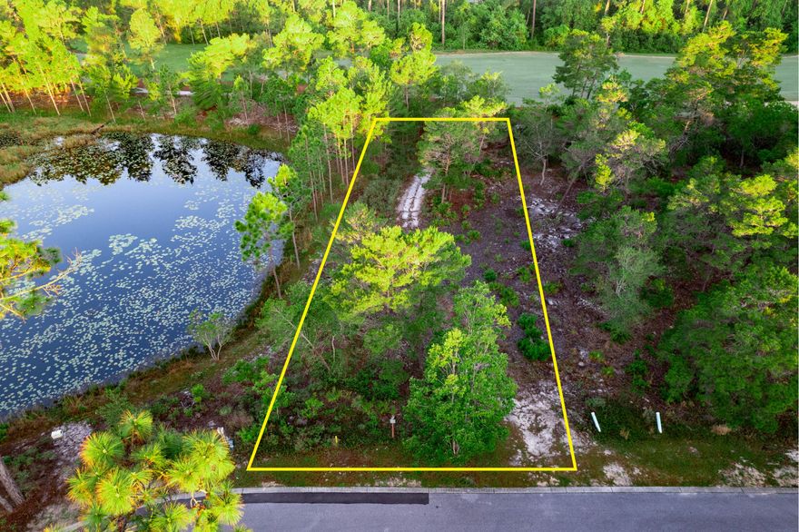WAKE UP EVERY MORNING ON THE WATER AND GOLF COURSE! This amazing lot is located in one of the most reputable and gated communities on PCB! Positioned perfectly alongside a a small lake filled with lily pads and fish!  Don't forget the golf course located directly behind this land.  Nestled in just enough woods to make this a trifecta for living...woods, water, golf AND it is tucked away on a cut-de-sac!Wild Heron has amenities not only for the golfer but tennis buffs too.  Hiking and walking trails, fitness center, heated pool, fire pits and so much more! Buyers must be accompanied by an agent.  Go see this gem!Submit all offers.