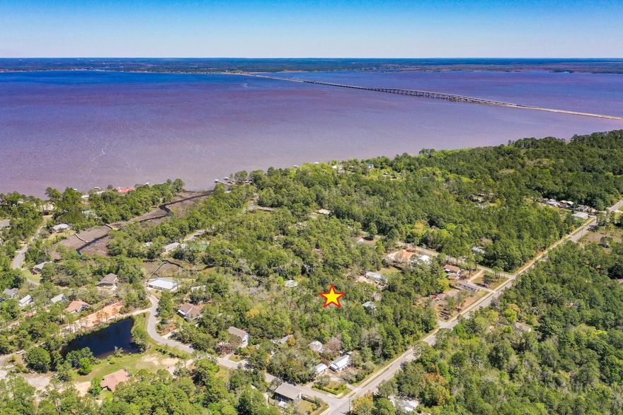 Build ready lot with water access to Bay (Kayak or paddle board).  Survey already done and  electric, water, natural gas, and sewer on edge of property. See docs for county approved clearing and building plans!  The majority of the lot is in the coveted flood zone X (no insurance required). Multiple new builds on street. The area is set to appreciate. No HOA. Make this your dream home with an amazing location just minutes from the beaches and all 30A has to offer.  Survey and building plans in notes.Property goes to middle of back creek. Lot dimensions and acreage from county site. As Always, Buyer to Verify All Items Deemed Important including lot dimensions and hookups.
