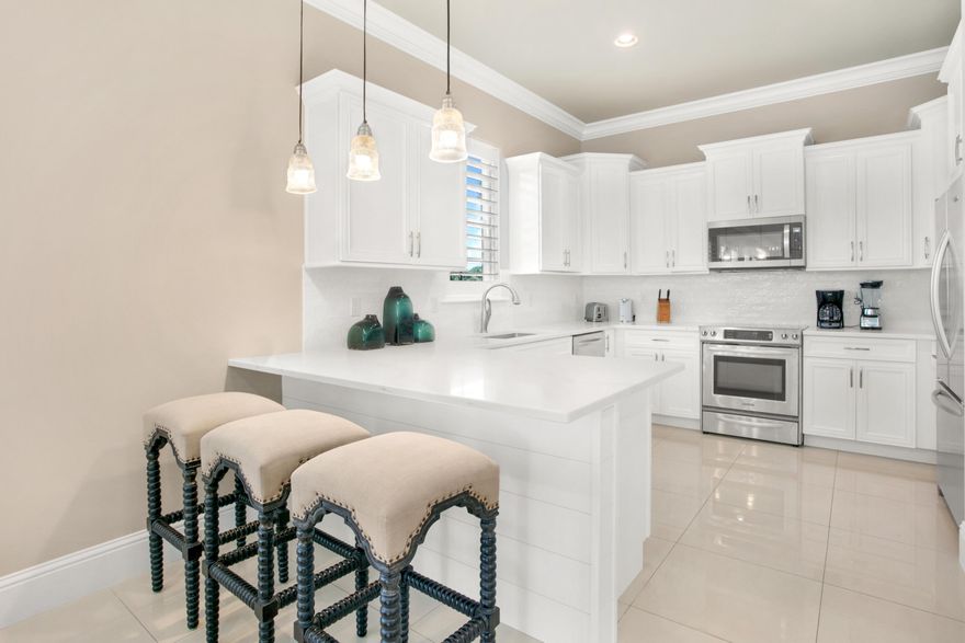 Luxurious estate with a garage and (2) golf carts, a 4-seater & a 6-seater. This home is tucked away at the end of the street for ultimate privacy and nestled between the 5th & 8th fairways of Baytowne Golf Course.  The entire home has been freshly painted! Step into the 2023 NEWLY RENOVATED KITCHEN, where every detail has been carefully crafted to create a space that is both functional and stunning.  Exquisite quartz countertops, dazzling backsplash, newly painted white cabinets with sleek hardware, stainless steel appliances, and shiplap walls under the breakfast bar. The kitchen, dining, and living area are wrapped in windows reflecting ample natural light off of the marble flooring. Convenient 1st floor bedroom and bath. Ascend to the upstairs where you will find the primary suite and