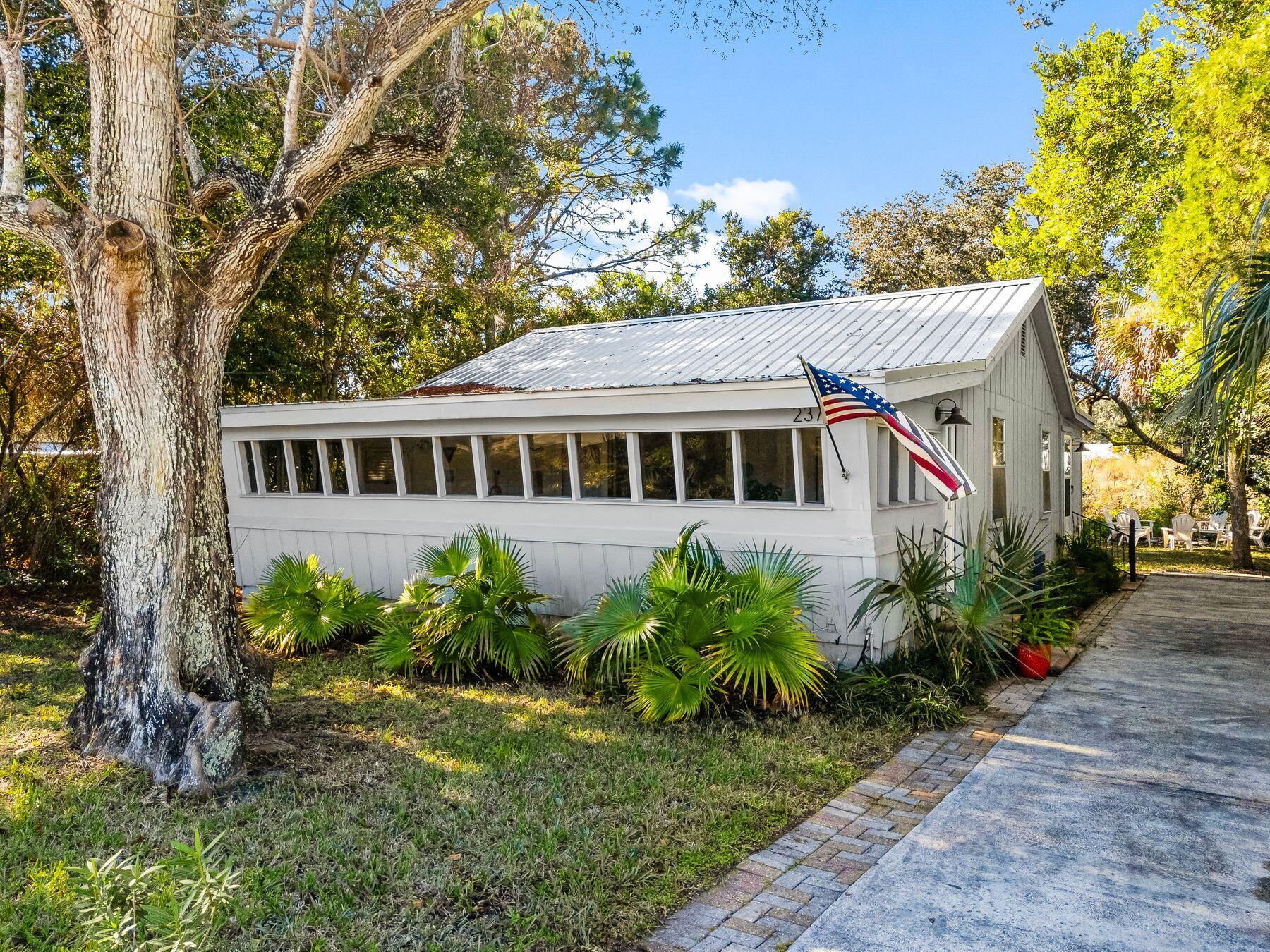 Tucked in the heart of Laguna Beach, this darling cottage embodies the quintessential beach lifestyle, just 1.5 blocks from the sugar-white sands and emerald waters of the gulf. Set on a generous 50x110 lot, this charming two-bedroom, two-bathroom retreat offers a perfect blend of vintage boho vibes and modern updates, making it an ideal second home or vacation rental.The home's inviting interior features fresh paint, updated flooring throughout and a newly renovated bathroom. A brand-new roof ensures peace of mind, and the property is being sold fully furnished, ready for you to start living the beach dream. Outside, a spacious backyard with a fire pit and seating area is perfect for evening gatherings under the stars. Laguna Beach's coveted location is a treasure trove for beach lovers, offering convenient access to the renowned Carousel Grocery Store, complete with a wine cellar and gift shop, and the iconic Thomas' Donut and Snack Shack. Enjoy easy golf cart or bike rides to the beach, or take a short drive to explore the vibrant dining and shopping options at Pier Park or along 30A. Free from HOA restrictions, this property provides the flexibility to embrace your personal vision of coastal living. Whether you're seeking a serene getaway or a savvy investment, this Laguna Beach gem offers an unparalleled opportunity to enjoy life at the beach.