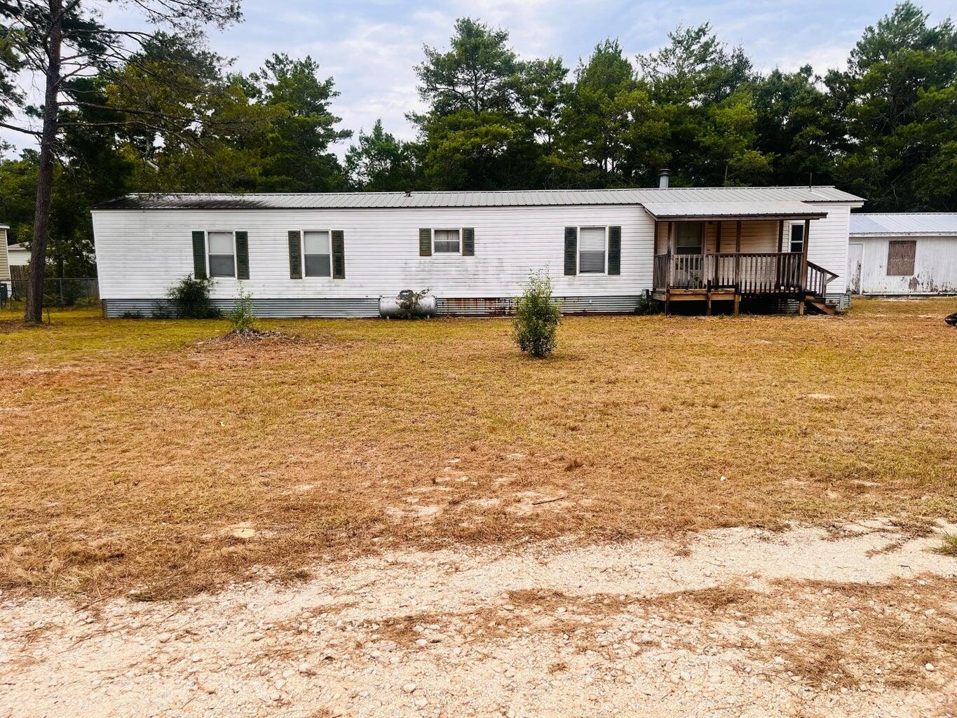 This 2-bedroom, 2-bath mobile home offers great potential for first-time buyers or investors. It features a functional layout with recent updates, including a newly renovated front porch and new flooring. An additional bedroom off the deck adds extra space, perfect for customization. The backyard showcases a nice deck and a fenced area for privacy and outdoor enjoyment. A shed built in the back  provides additional storage. While some finishing touches are needed, this home has a solid foundation and offers a fantastic opportunity for further improvements