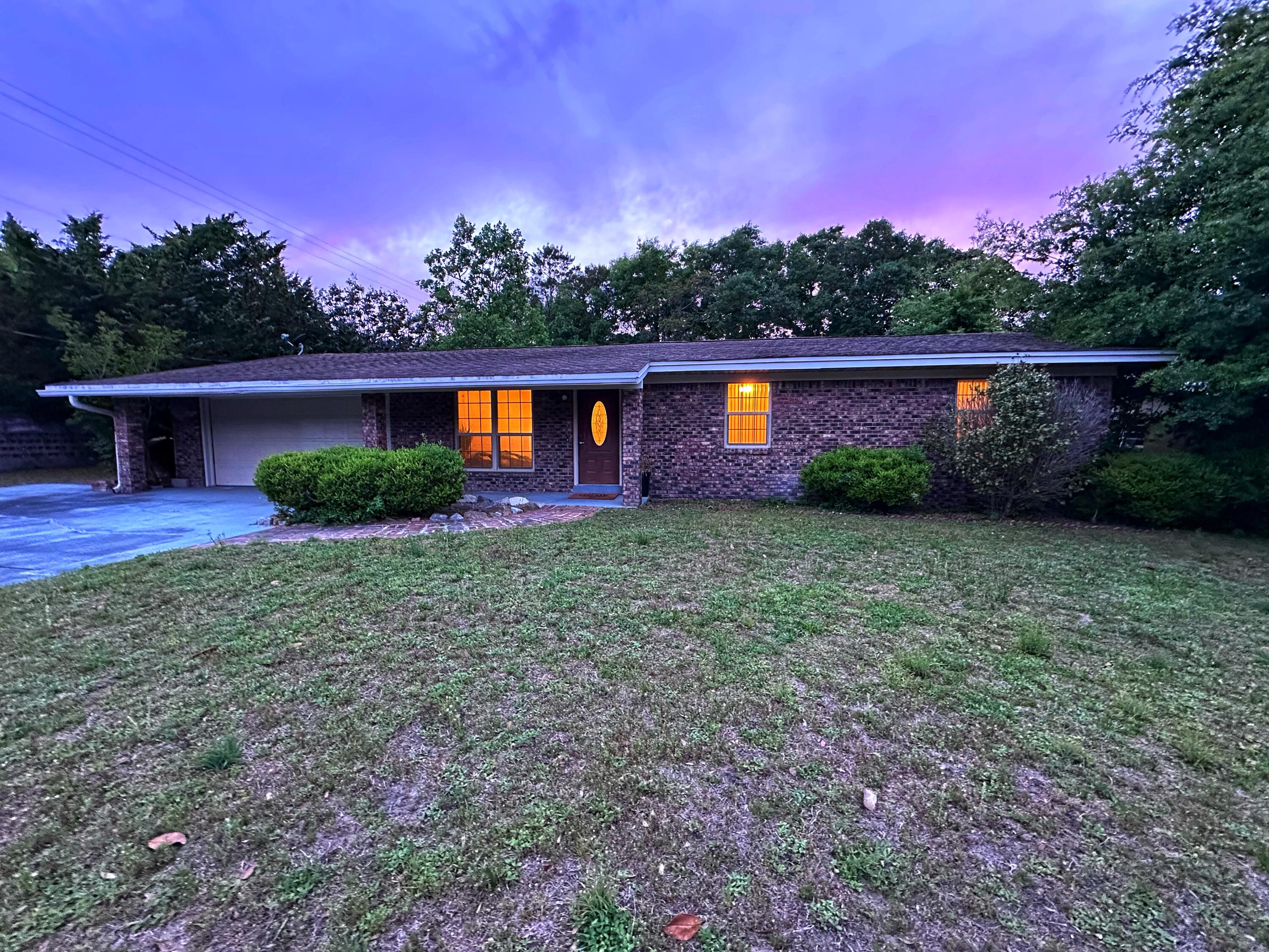 Welcome to this centrally located ranch-style home in Fort Walton Beach -- where natural light, a flexible layout, & the ultimate backyard escape come together.Inside, you'll find two spacious living areas & a centrally placed kitchen that makes everyday living and entertaining feel easy. The den or dining space features a stunning floor-to-ceiling gas fireplace feature wall & a sliding glass door that opens right onto the expansive backyard. The large, fenced yard offers storage options & plenty of space for parties, water games, or shade on a summer day. An extended driveway adds room for vehicles, a boat, or visiting guests. Bonus: No HOA--but there's a well-kept neighborhood park just steps away! New roof with accepted offer, move-in ready.