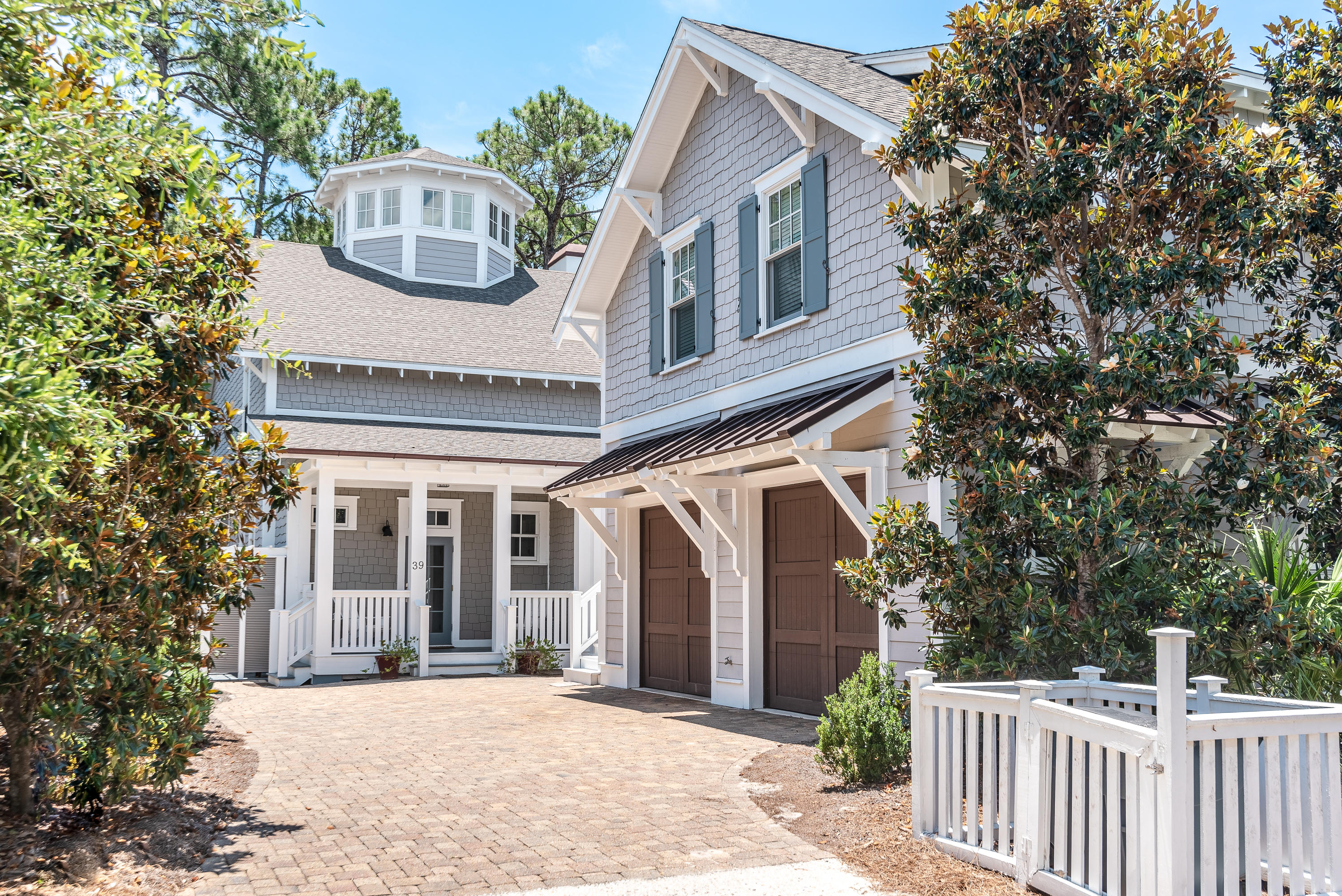 This immaculate WaterSound home provides high-end luxury living with all the add-ons. The home backs up to natural wooded space and Yacht Pond giving you serene living. The main home features four bedrooms with the master bedroom, additional guest room and kitchen located on the first floor. There are two more guest bedrooms located on the second floor plus a bunk room with built in bunks and additional sleeping space. Beautiful hardwood floors flow throughout the house. The third floor features a 360 octagonal shaped tower that overlooks the community and boasts gulf views. New upgrades include custom shelving in all the closets, kitchen pantry, and linen closet. Additional shelving has been added in the kitchen for extra storage. The exterior and interior of the home