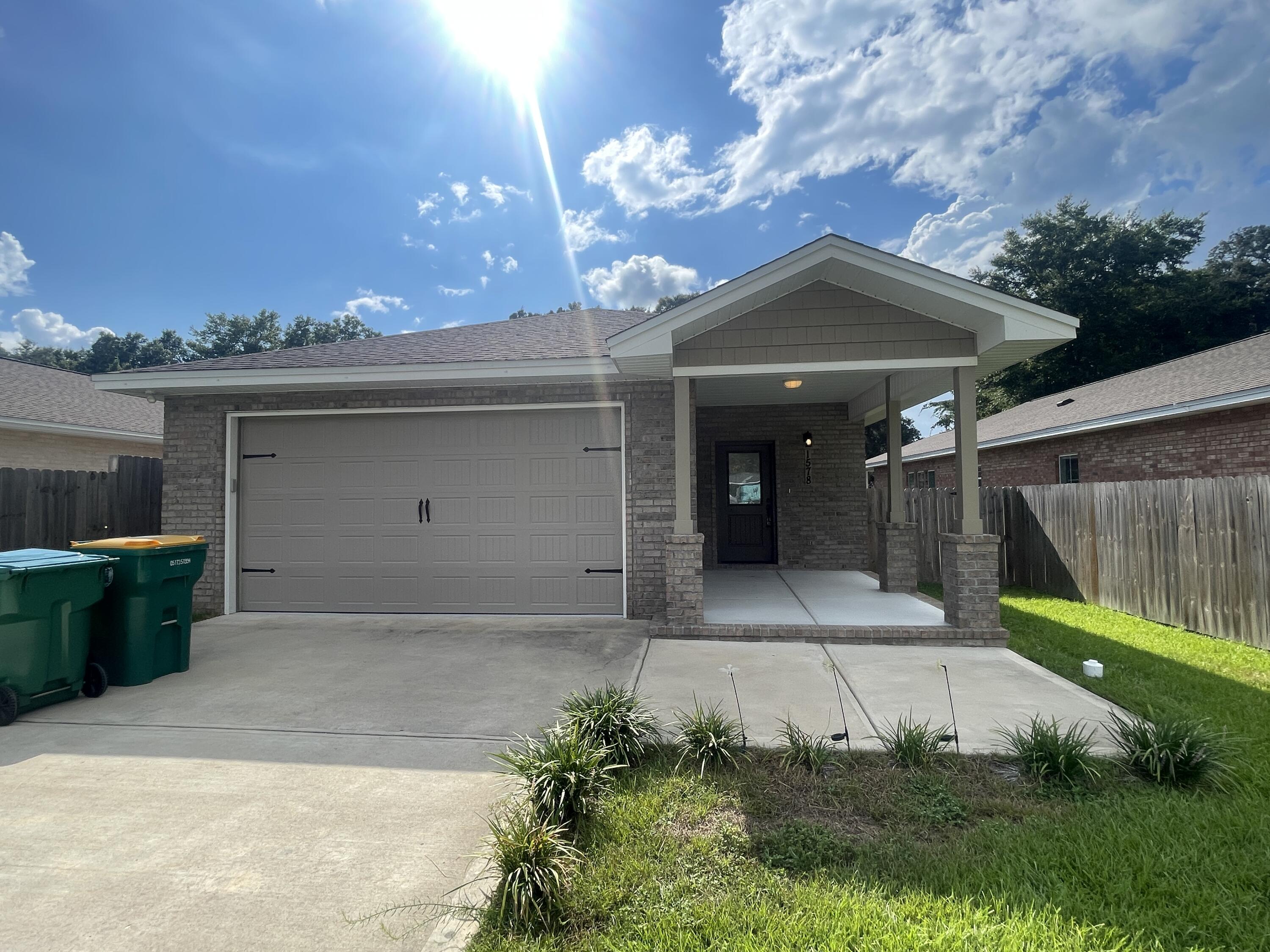 Step into this absolutely stunning 3-bedroom, 2-bathroom home, built in 2021! Enjoy the modern comforts of newer construction paired with an unbeatable location, just minutes from local military bases, within walking distance of the elementary school, and with quick access to the Mid-Bay Bridge for trips to the beach, shopping, dining, and entertainment.This home immediately impresses with its charming curb appeal, a welcoming covered front porch, and a spacious, privacy-fenced backyard complete with a covered patio--perfect for relaxing or entertaining. The two-car garage offers ample space for parking and storage.Inside, you'll find a bright and airy open floor plan with recessed lighting, contemporary finishes, and neutral colors throughout. The living area flows seamlessly into the formal dining space and the kitchen, which is outfitted with granite countertops, stainless steel appliances, a large island with a breakfast bar, plenty of cabinetry, and a convenient pantry.
The primary suite, tucked away at the back of the home for added privacy, is generously sized and features an en suite bathroom with dual vanities and a walk-in shower. Two additional bedrooms offer plenty of space and share a full guest bathroom.
Pets may be considered with prior owner approval and a non-refundable pet fee. No smoking permitted, including vaping.