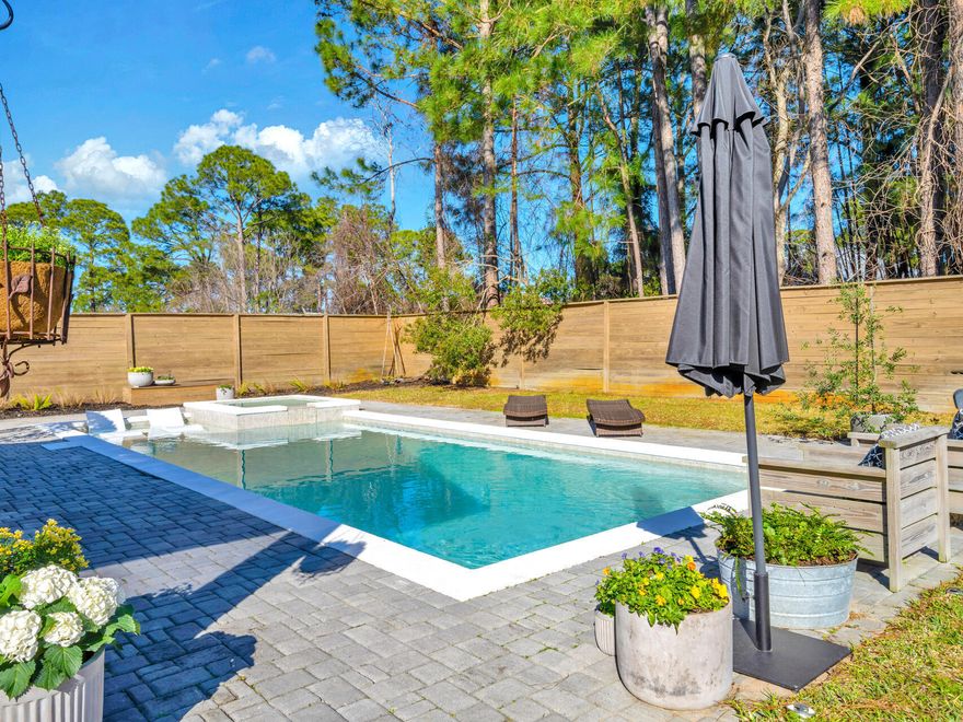 You are not going to want to miss this home.  Beautiful saltwater pool with hot tub? Stunning garden? And so many upgrades that we couldn't fit them all on one page? This home has been renovated, quite literally, from the floors to the ceilings.  Did we mention the less than 5-minute drive to the beach? Large quarter acre lot, and NO HOA?Stepping into this property is like stepping into a lifestyle. As you enter through the front door, you'll instantly notice the light and airy atmosphere with the solid hardwood flooring and limestone plaster walls which can be found throughout the main living and dining areas.  The kitchen has been completely remodeled. Features include custom maple cabinets, Fisher Paykel appliances, Carrera marble countertops, and an apron sink. In the primary bedroom you will find shiplap walls and venetian plaster ceilings.  The primary bathroom was completely remodeled, including marble flooring, Carrera marble countertop, venetian plaster ceilings and walls, and handmade ceramic tile in the walk-in shower. The primary closet also boasts custom built-ins.  Over to the other side of the house, you'll again find those sleek shiplap walls and venetian plaster ceilings in both guest bedrooms, the shared bath, and hallway.  The guest bath has also been remodeled including same flooring, countertops and toilet found in the primary bathroom.  

There is ample parking space thanks to the paver driveway which can comfortably accommodate 4 vehicles, along with the attached 2-car garage.  Inside the garage you will notice the clean epoxy floors, and more built-in shelving for all your storage needs. 

Now to the real gem of the property...the BACK YARD. Stepping out of the kitchen and into the screened-in porch, is the breathtaking outdoor space, a private oasis, if you will. With pavers lining the porch, surrounding the large pool deck and headed into the whimsical garden. The porch boasts a sitting area as well as a dining area, perfect for enjoying dinner with friends after a day at the beach or in your private salt-water pool. Enjoy a day swimming, lounging on the sun shelf, or relaxing in the hot tub. The large yard also allows for tons of outdoor activities like yard games or hosting the perfect garden party. Speaking of gardens, following the pavers around the pool, you are led into the stunning flower garden where you can always have fresh cut flowers year-round. This home is truly something special.

What about the location? It's prime! Being a short golf cart or car ride away from the beautiful public beaches of Miramar Beach (5 minutes), and only 5-10 minutes from restaurants, entertainment, shopping, and so much more. Places like Pompano Joe's, Whale's Tail, Seascape, Surf Hut, and Silver Sands Outlet are all just a short drive away.  
