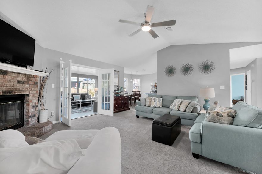 Quayside Village is a quiet and cozy neighborhood. Open and functional floor plan, with ample storage in the 2 car garage and shed in the back. Entire home repainted with soft neutral color, with open large great room/living area with a cozy brick fireplace and a spacious kitchen featuring tons of counter space and storage with cabinets and stainless steel appliances that boasts vaulted ceilings, tile floors, and a large breakfast island. Master Suite has a trey ceiling and ceiling fan. Master bath includes a double vanity, garden tub with a separate shower, Carrara counters (in both bathrooms), and walk in closet. Wood burning fireplace and French door leads out to four season Florida Room and backyard with a beautiful landscaped yard with grapefruit trees, moscato grape vines, pear tree,