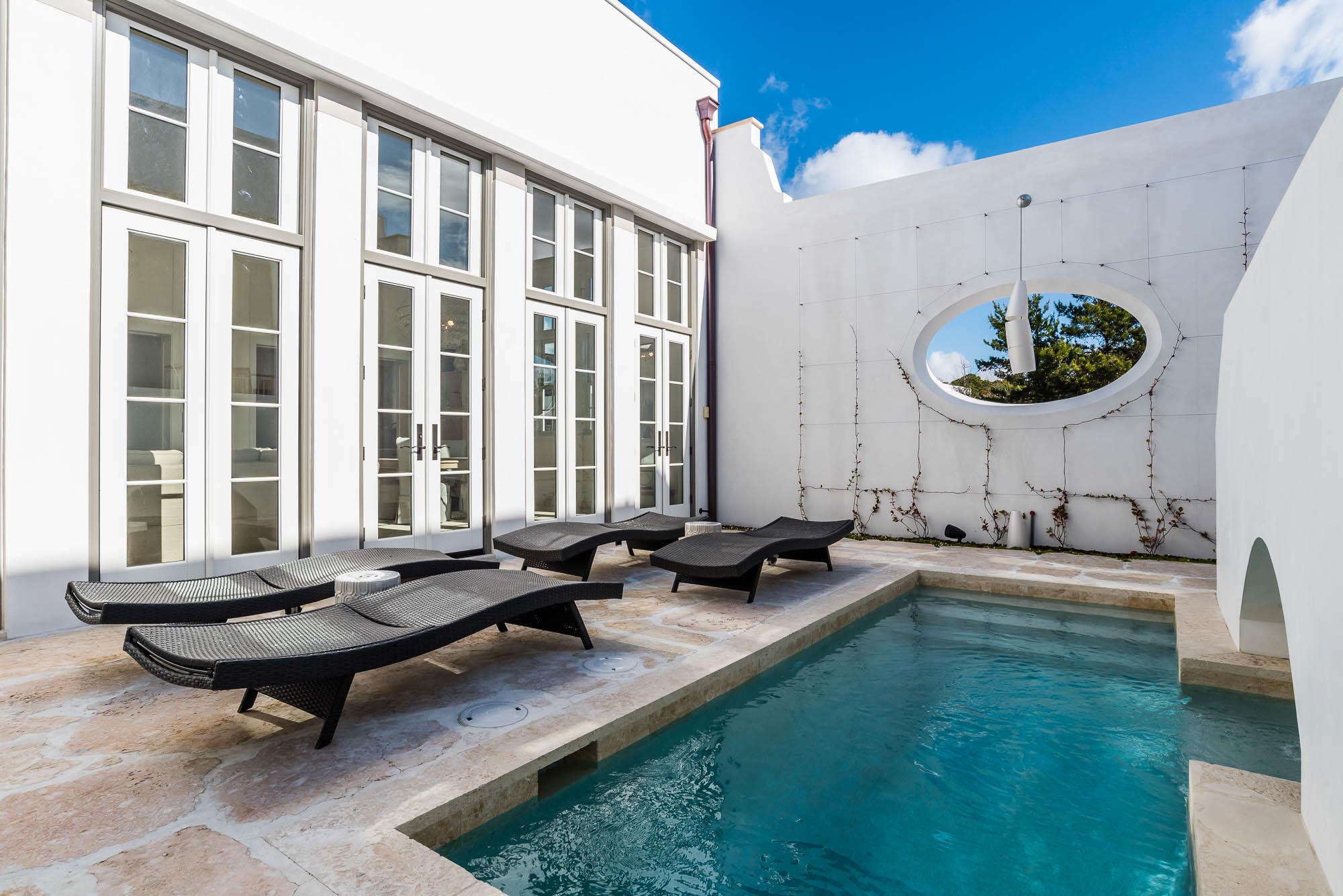 Exceptional location and beautiful architectural details woven into every space of this 4 Bedroom, 4.5 Bath home make this a rare find. Fall under the spell of sophisticated coastal living in a corner situated light-filled private oasis. Caliza Courts rowhomes are designed by the renowned Khoury-Vogt Architecture team and form a welcome addition to the breathtaking Caliza Pool location.Impressive scale of the great room awes with 16-foot ceiling,12-foot tall French doors and windows opening to a private courtyard complete with private heated pool, and guest suite beyond. Floor plan offers the utmost in comfort to accommodate friends and families. Venetian Plaster reflects the elegance of the surroundings. The open concept kitchen offers top of the line Thermador appliances, oak