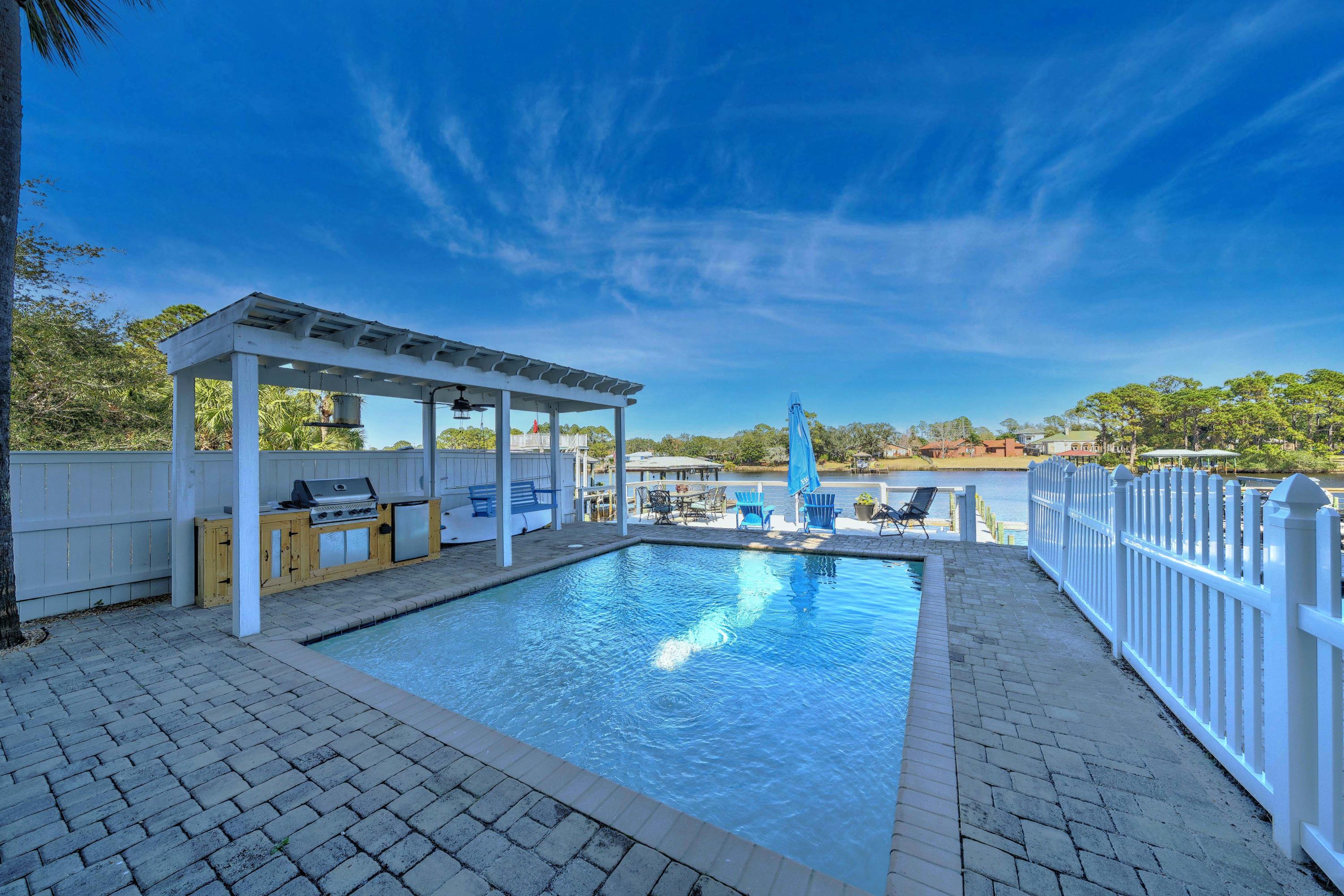 Fantastic WATERFRONT home on Grand Lagoon. This home has everything you would desire in a waterfront home. Inside this 4 bed/4bath home has a hydraulic elevator that reaches all floors, solid Brazilian Cherry flooring, 10 foot ceilings, 8 foot doors, a designer kitchen with an oversized Wolfe range and oven, Subzero refrigerator, Bosch dishwasher and a built-in ice-maker. All bedrooms have balconies overlooking the Gulf of Mexico or Grand Lagoon and each has its private bath with Jacuzzi tubs. For convenience there are 2 laundry rooms one on the 1st floor and one on the 3rd floor. The backyard offers an unground, heated, saltwater pool, outdoor kitchen, lanai, boat dock to accommodate almost any sized boat with electric, water, cable & phone service on the dock.