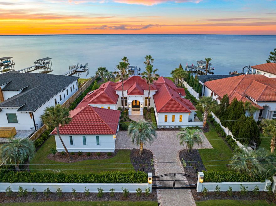 Exemplary positioning along the beautiful Choctawhatchee Bay juxtaposed gated privacy and manicured grounds characterizes this striking waterfront retreat primely located in the heart of Miramar Beach in Walton County, Florida. Notably remodeled, this exceptional home features a brand new roof (2022) as well as an updated interior & exterior palette yielding a sophisticated coastal design by Mary Ezell and executed by the talented team at Magnolia Custom Homes.