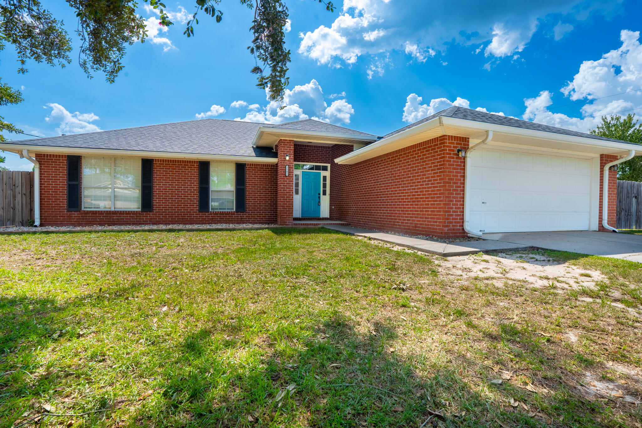 Beautiful 4BR/2BA brick home on a large corner lot in Hampton Ridge Estates, Navarre. This 1,783 sq ft home features vaulted ceilings, a wood-burning fireplace, fresh paint, and LVP flooring throughout. The kitchen includes stainless steel appliances, and the master suite offers a walk-in closet and double vanity. Enjoy a fully fenced yard with double side gate, sprinkler system with well, and a two-car garage. Move-in ready , schools, shopping, and Navarre Beach!