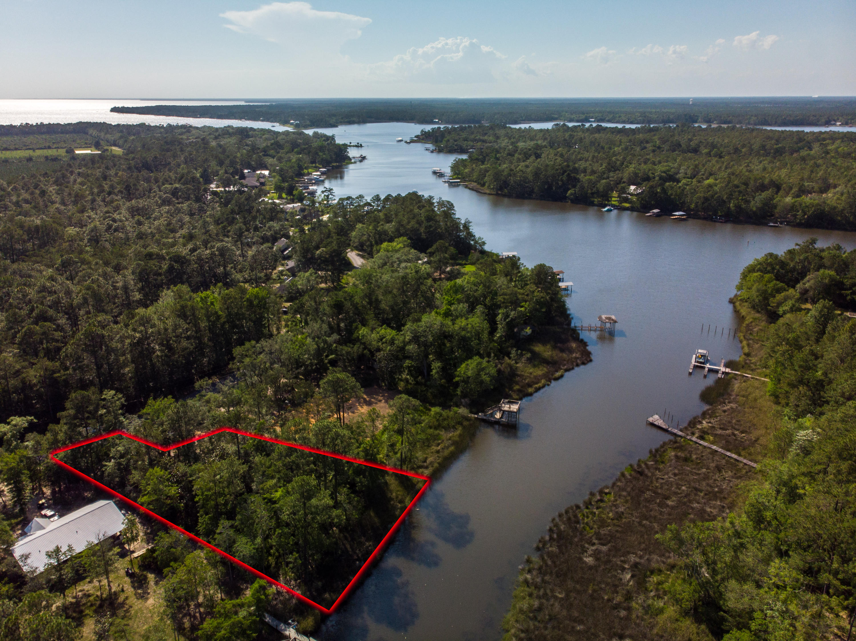 Very few waterfront lots left in Freeport and this one is on Mallet Bayou with 150' on 3/4 acre! Live the dream on the water in Freeport, minutes from the beaches, shopping and dining in South Walton, but the ''getaway from it all'' feeling you get on the north shore in Freeport! These properties only come once! Survey available with topographic and wetland delineation. Partial X flood zone.