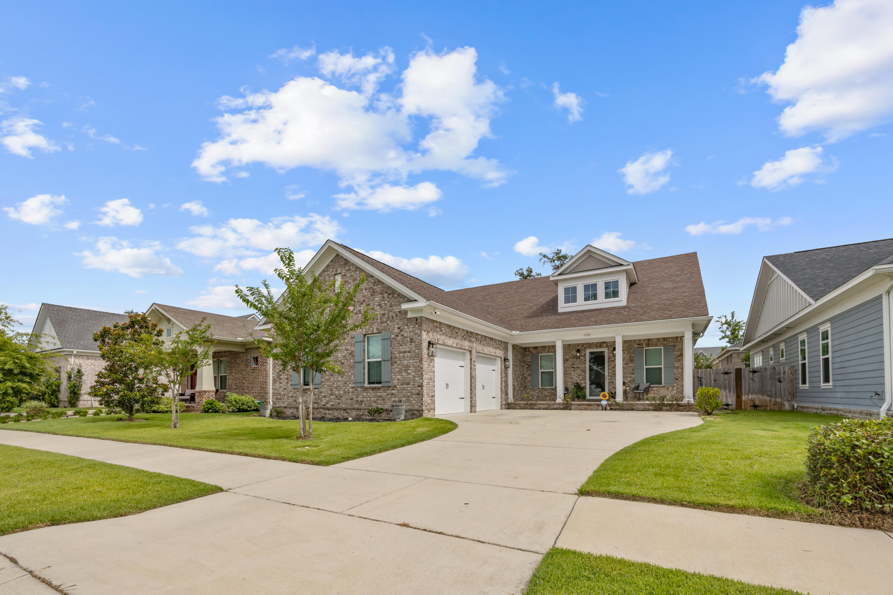 This beautiful brick, move-in-ready, 4-bed, 2.5-bath home with an open floor plan is located in the sought-after Deer Moss Creek community, which offers social events, walking trails, a pavilion for community events, and a pool coming soon. Enjoy the convenience of a master suite on the first floor, featuring a spa-like bath with a soaking tub, separate shower, and quartz countertops. The home boasts too many upgrades to mention, including an upgraded marble fireplace with floating shelves and built-in cabinets, and upgraded flooring throughout. The gorgeous kitchen is a chef's delight with custom cabinetry in the pantry. The oversized garage features built-in cabinets and an epoxy floor. Control the garage doors with your phone for added convenience. Relax on the screened outdoor porch