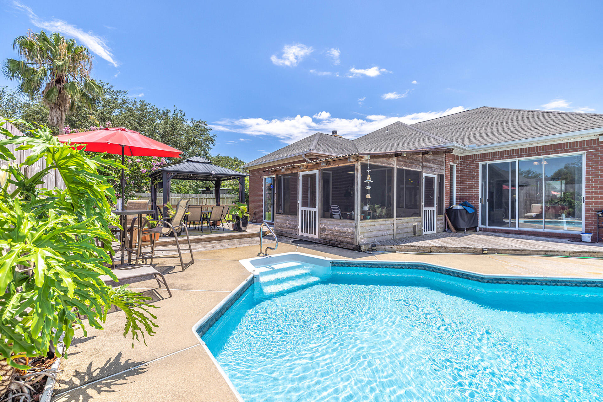 Check out this wonderful POOL home located South of Hwy 98, and just minutes away from Hurlburt and the beaches of Navarre! This split floor plan home offers 3 spacious bedrooms, 2 baths, an updated kitchen with granite counters, stainless steel appliances, and beautiful tile floors through out the living area! The family room features a fireplace with tile accents, large dining area, & a secondary living space. Enjoy your time outside in either the large screened enclosure, taking a dip in your pool, or gathered with friends and family around a patio table on the oversized deck! The master bathroom features a double vanity with granite counters, jetted tub, tile shower, and large walk-in closet with custom shelving. Schedule your showing today before this wonderful home is sold!