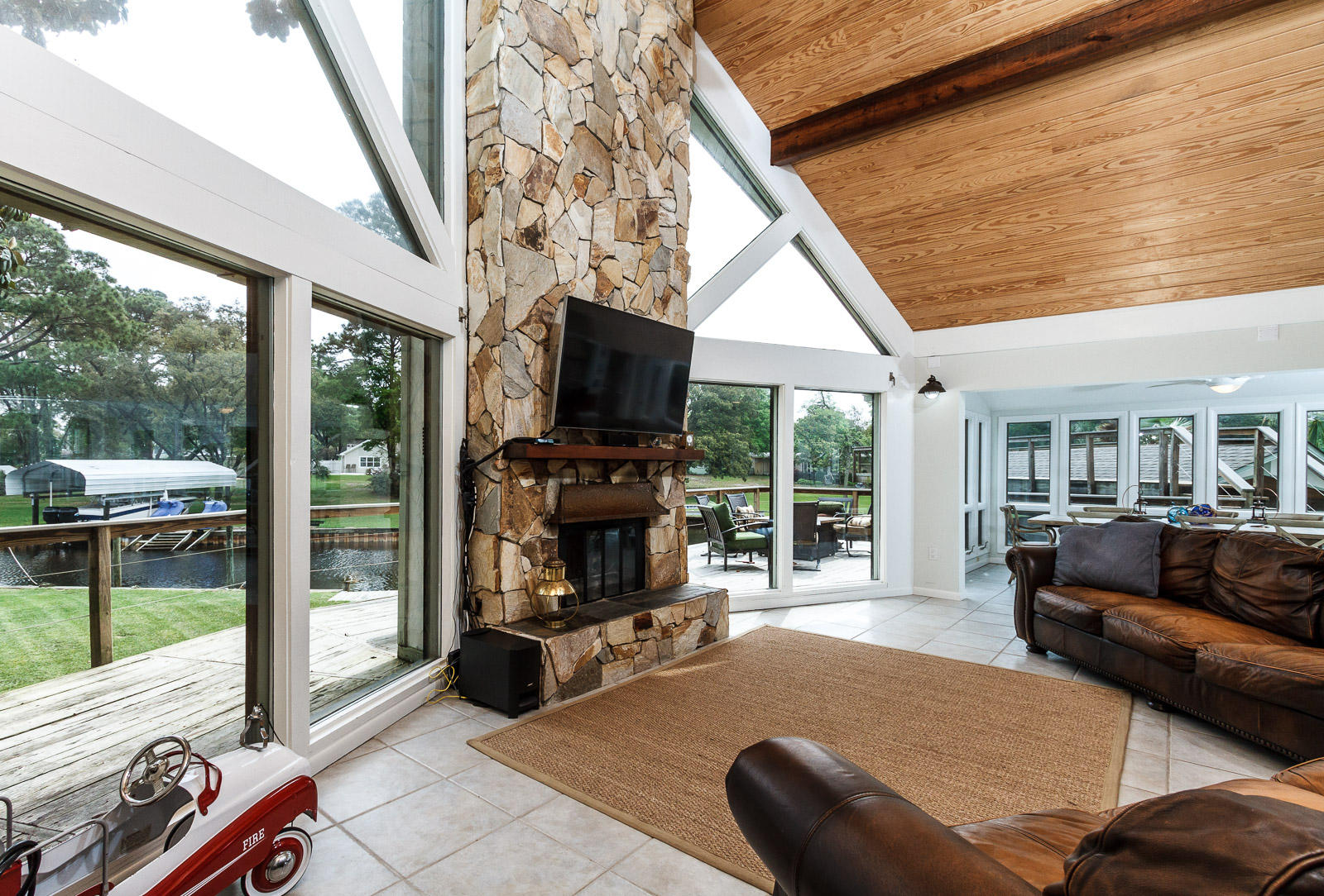 With well over 100ft of waterfront, two boat lifts, boat house, and a tie along side slip for a large boat, this is truly a property for a water loving family or sportsman. The house features an excellent open floor plan with a large living and dining area that has two story cathedral tongue and groove ceilings centered around its large fireplace and floor to ceiling windows that look out toward the water. Downstairs are two bedrooms and a full bath, and a unique spiral staircase takes you to the exceptional loft and master bedroom/bath upstairs. A rare feature on this house is its walk-in and insurable basement to store all of your gear or have a workshop. Outside are expansive decks, newly brickpaved walks and drive way, and a bridge to the boathouse roof deck. Bay Access. Must see!