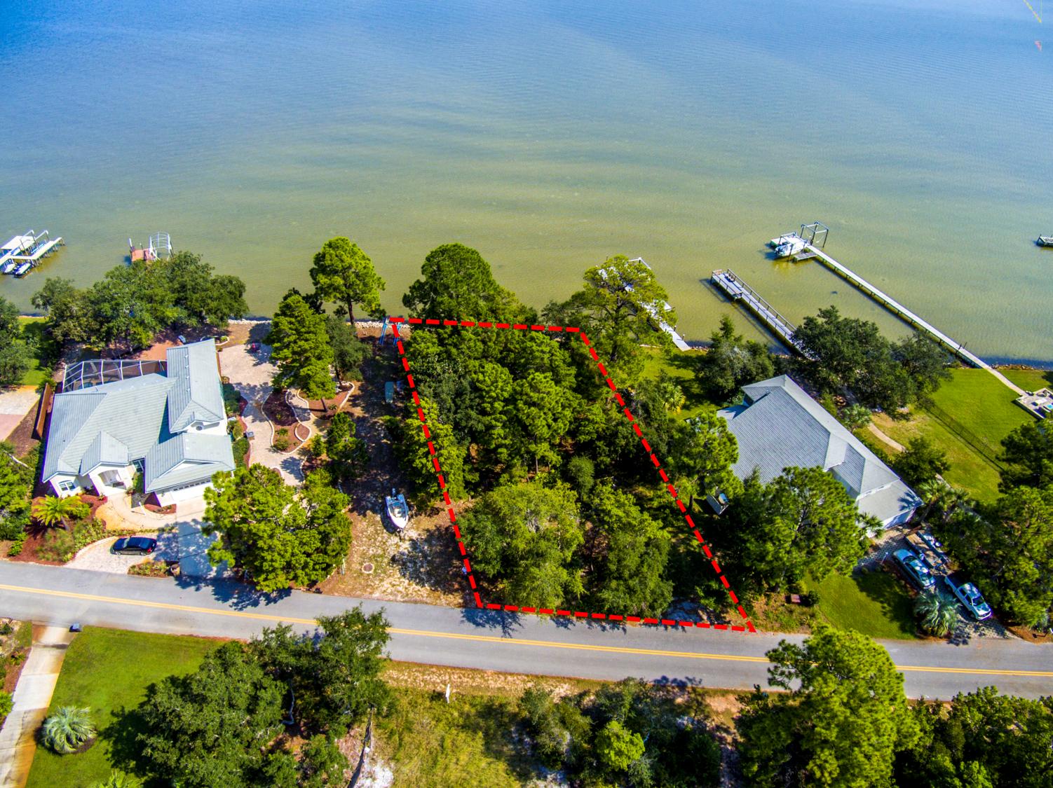 Located in the well established gated subdivision of Pelican Bay, this would be the perfect place to call home! This lot sits directly on the Choctawhatchee Bay with gorgeous panoramic water views. Excellent location near Sacred Heart Hospital, Grand Blvd, just East of the Sandestin Resort and beach access at Topsail Hill State Park and the intersection of 30A and Highway 98. Community amenities include tennis court and bayfront park with dock. This is an ideal place to build your dream home on the Bay and there is no required build out time. City water and sewer are available and all utilities are underground. All measurements to be verified by buyer.