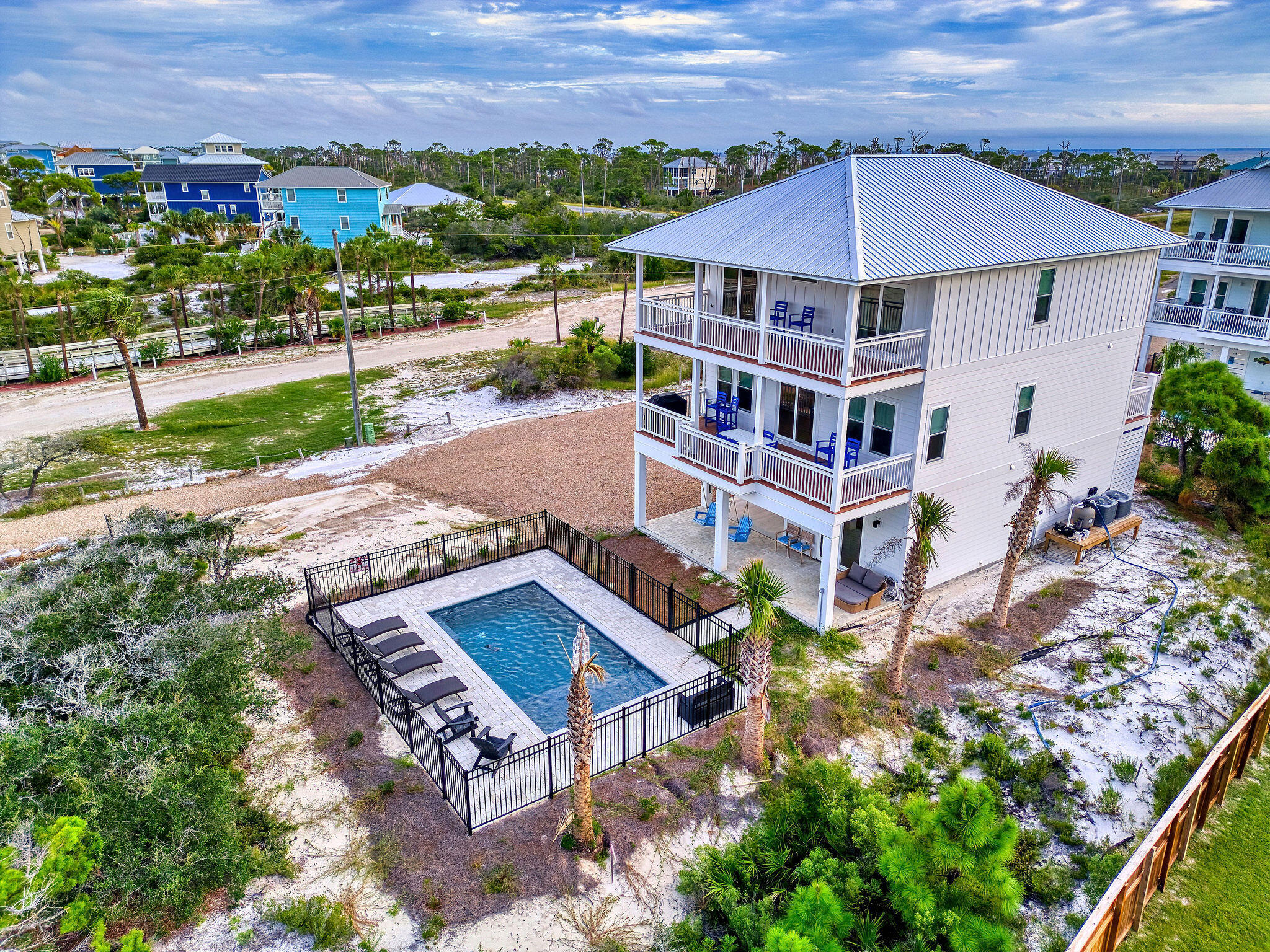 Best Deal on Cape San Blas and the easiest/quickest beach access of any non-gulf front home on the Cape. Private pool and on a huge lot with great beach access and golf cart included for taking advantage of the park next door. Sellers are ready to sell and have furnished the home and reduced $325K! This home is brand new with top of the line durable finishes that allow it to have reasonable homeowner's insurance and it's in X flood zone which is the best zone in Florida. Never rented and in pristine condition. This is one of the best 2nd tier lots you'll ever find and the home sits entirely in the X flood zone. Being in the X flood zone, there is a full bathroom downstairs that's very convenient for the pool and also a large enclosed outdoor shower. The property overlooks Cape Palm Park, which provides protected views and lots of extra amenities. It's awesome to go to the beach and have the pavilion, bathroom, and rinse off/shower right there at the boardwalk. It's a huge lot with tons of room for outdoor games, a firepit, and additional parking and or outdoor kitchen if desired. (No home can be built between this home and the lot in front of it) Make sure to check out the virtual tour. No HOA fees or rental restrictions. Fully furnished and equipped as shown and beach golf cart and Starlink equipment included: truly move in ready. Sellers will entertain owner financing with at least 20% down. Listing agents are the owners. Have rental projection from Sunshine Vac Rentals in the $140-150k range and Be Our Guest Vac Rentals for $134k.