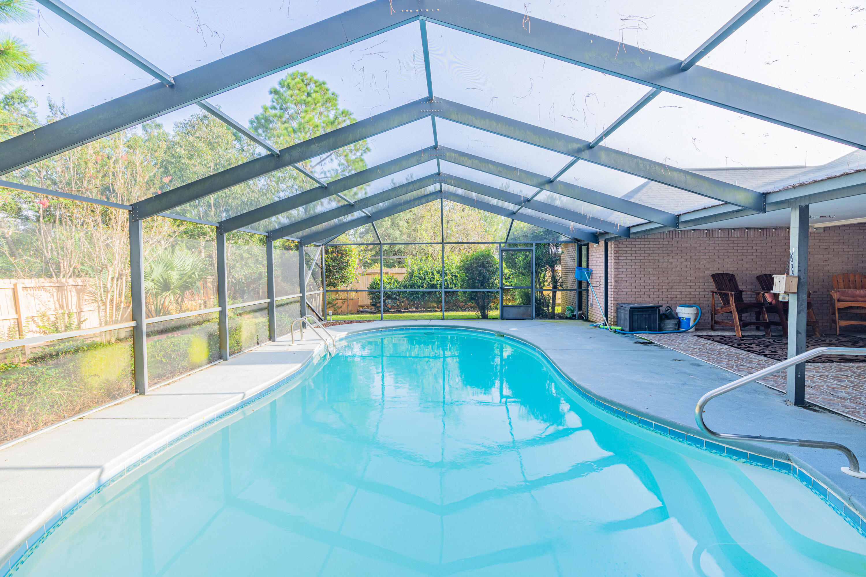 Back on market and NEW ROOF coming. MUST SEE POOL home in Pritchard Point S/D. Screened IN-GROUND POOL and rear patio area with tile flooring, great for entertaining. Private beach access along Santa Rosa Sound. Approximately 6.5 miles to Hurlburt Field AFB. Short drive to shopping and the white sandy beaches of the Gulf. Wood flooring in living and dining area, tile and carpet throughout rest of home. Kitchen has stainless steel appliances, center island, smooth cooktop, beautiful copper vent hood, breakfast bar, built-in wine rack, tile backsplash, tile floor and plenty of counter space, drawers and cabinets, not to mention the eat-in kitchen overlooking pool. Family room has a gas brick fireplace with raised hearth and wooden mantle. Double French doors lead out to the pool area.
