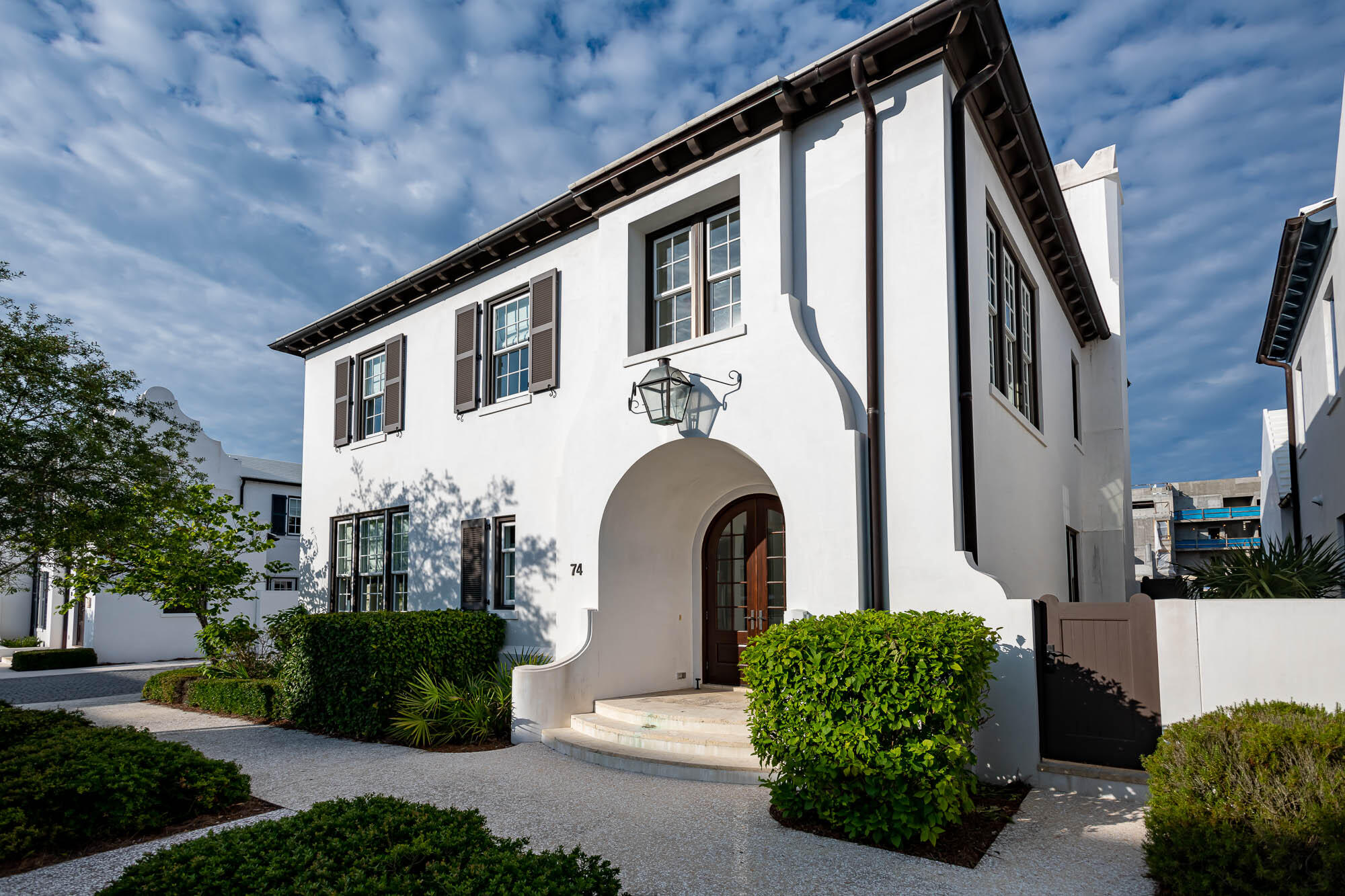 The perfect blend of elegance and a family-friendly beach home on one of the most desirable streets in Alys Beach, Nonesuch Way. Architect Gary Justiss designed the first floor with an open floor plan, first floor bedroom and two-car garage. In all, 74 Nonesuch Way has 4 bedrooms, 4.5 baths + a separate bunk room that sleeps 4. Masterfully articulated by Urban Grace Interiors, the interiors combine bright colors mixed with the understated elegance of the coastal white palette of Alys Beach. The kitchen boasts a 48 Thermador Range, 36 Thermador refrigerator, espresso machine, warming drawer, walk in pantry with drink refrigerator, Caesar stone honed countertops with a marble backsplash, island with seating and generous cabinet storage. A well-appointed laundry room is just off the kitchen.