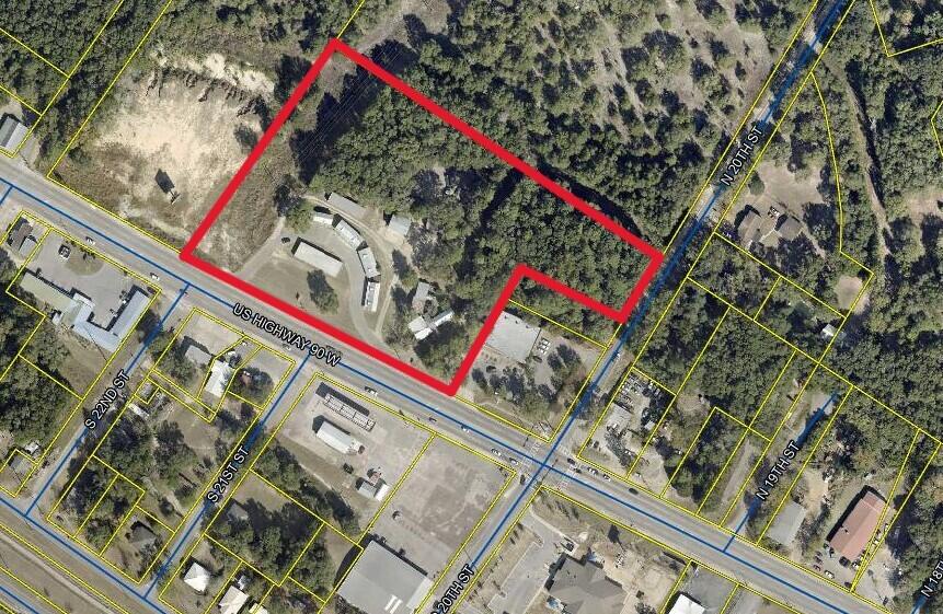 Location! Location! Location! Approximately 6 acres Zoned industrial right on Hwy 90 in DeFuniak with additional frontage on 20th street. New traffic light installed at the intersection of 20th street and Hwy 90. This property wraps around O'Reilly's Auto-parts with roughly 125 ft on 20th street and over 500 ft on US Hwy 90. Currently used as a self storage facility the property has over 10,000 sqft of different types of buildings from office space, warehouse space, Industrial Shop space, parking and outdoor storage, to an apartment. Chain link fenced parking. Located conveniently in the middle of town between Schools, shopping, and other businesses. Tons of potential. Property will be deed restricted at closing to not be allowed to function as a self storage facility.(mini storage)