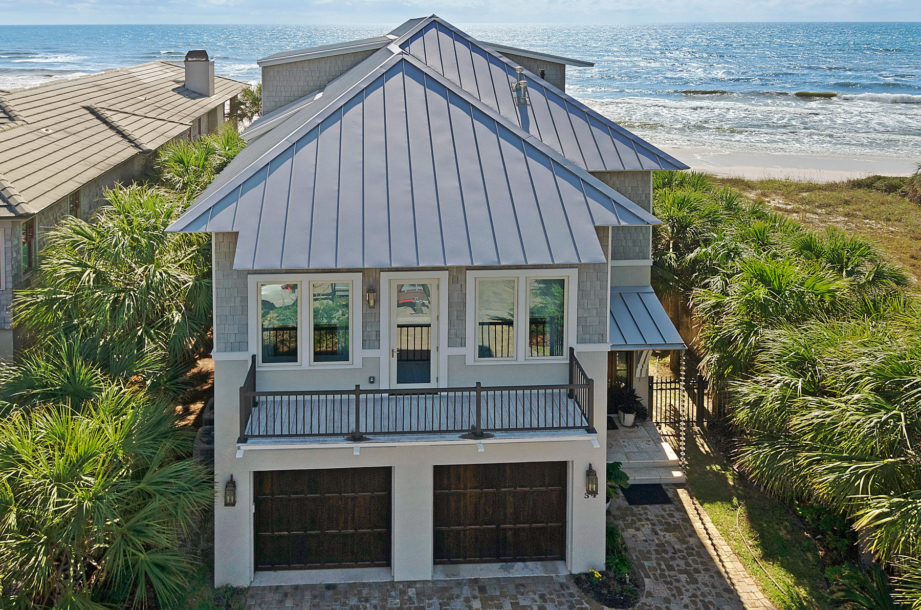 SUNSETS OVER THE GULF OF MEXICO! Life will be much sweeter relaxing on the multilevel decks of this magnificient 4100 square foot home located directly gulf front. At a sea level of 26', this home offers Panoramic views of the emerald green waters from almost every room in this 4 bedroom, additional bunk room and 5-1/2 bath home. Enjoy time with family and friends outside in the pool or take a picnic lunch and walk over the private custom designed beach walk to the powdery white sands of the Gulf. The Home is complete with a theater room on the 3rd floor finished with Pecky Cypress walls, wood ceiling, wet bar, billiard table and deck to relax and watch the sunsets. Home is being sold fully furnished with exquisite furniture and accessories and is move in ready.