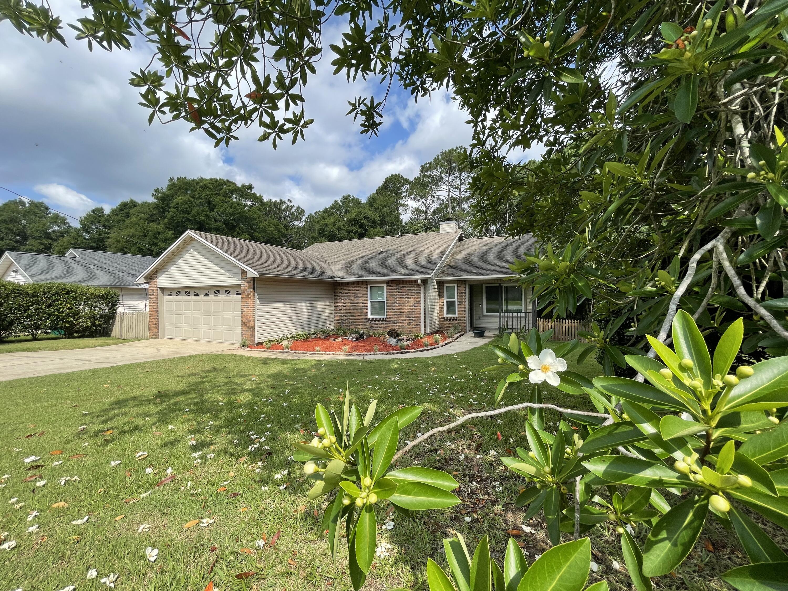 Absolutely adorable south Crestview home! This home has been lovingly maintained and it shows in every detail, both inside and out. Situated on a beautiful, large corner lot, with its own ''babbling brook'', you'll love relaxing on the deck or the screened porch and listening to the water flow and gazing at the beautiful landscape. The interior is freshly painted, has all LVP and no carpet, new windows, charming brick fireplace, nice appliances and nice little touches everywhere that will please and surprise. This is a must-see home, so if you interested, get on the phone now!