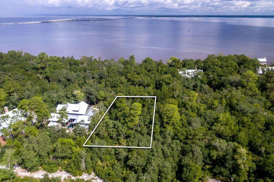 This exceptional interior home site offers endless opportunity in the Bay front Community of the Estuary. Backing up to thousands of acres of Point Washington state preserve and nestled between large pines and stunning magnolias. This home site is truly one of a kind admist the only 39 total home sites located within the serene and secluded gates of the Estuary. The Estuary has a newly built community dock offering bay front living amenities for those that reside in this exclusive community. This large home site is just a five minute drive from the sugar white beaches and emerald green waters of the Gulf giving you the best of both the bay life and the beach life just outside your door. You are also just a five minute drive from