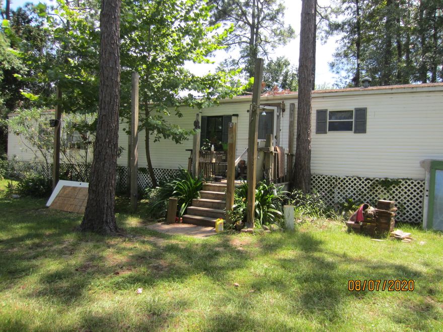 3BR/2BA single wide mobile home on two lots. Public water and public sewer. There is 100 feet of frontage on Santa Rosa Street and the property is 125 feet deep. It is located in the OLD HISTORIC TOWN OF Santa Rosa. Great location North of Hwy 98 and easy to access the beaches, bay, and amenities of South Walton. Just a short distance to Hogtown Bayou where you can launch a boat. Excellent value for owner occupant or to use as a rental property.