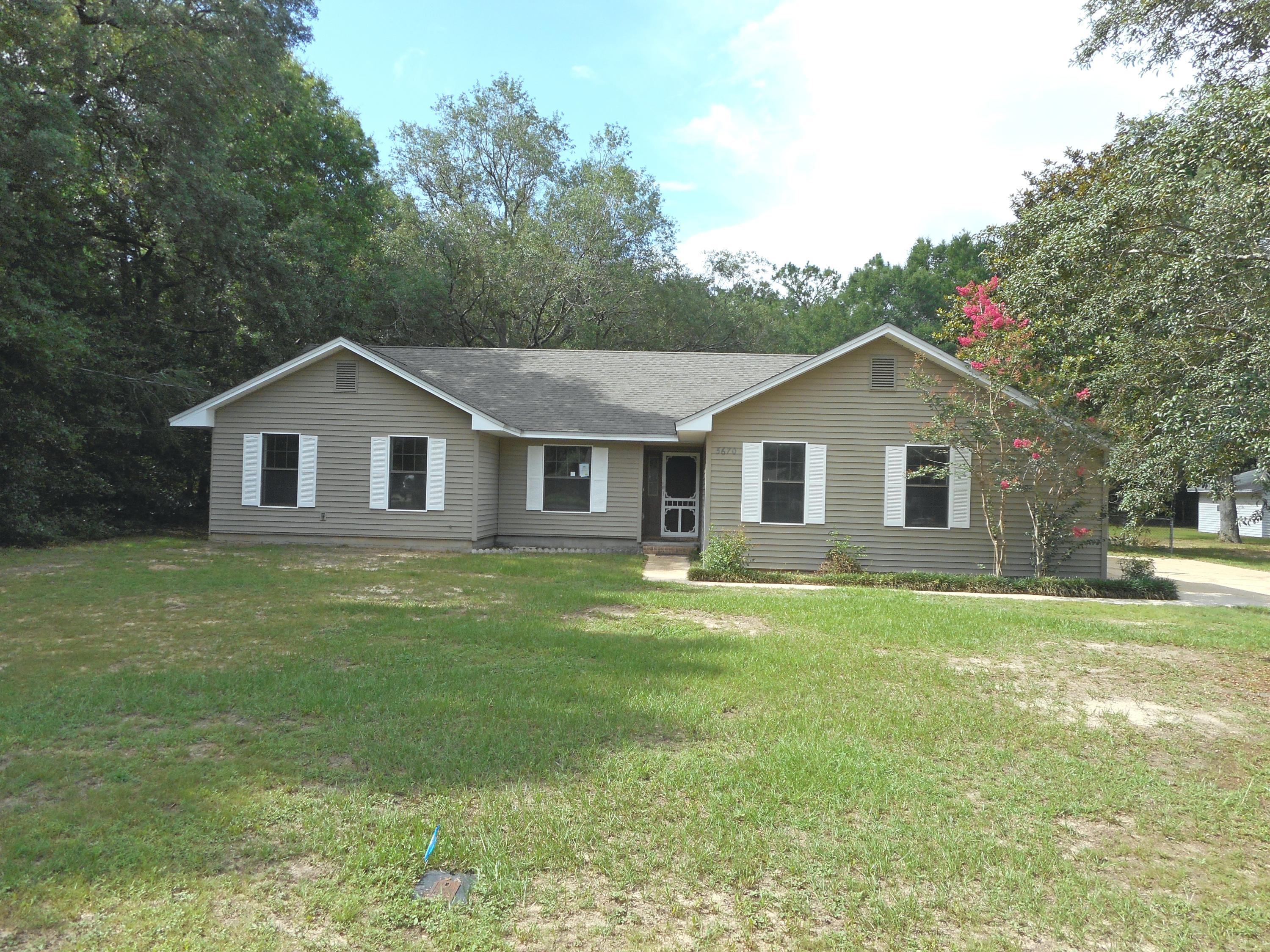 Delightful & bright 3/2 residence situated on a large wooded lot in a quiet neighborhood convenient to schools, shopping & Hwy 90. The split bedroom floor plan has been freshly painted inside & new carpet was installed in the bedrooms. Features include tile & laminate flooring, French doors, formal dining room, spacious living room with fireplace & a Galley style kitchen with all new appliances & ample cabinet & counter space. The master suite has a walk in closet & private bath. All Information recorded in the MLS is intended to be accurate but cannot be guaranteed, buyer advised to verify. Sold As-Is.