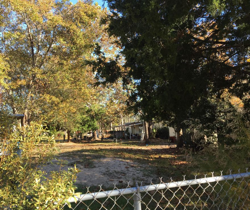 This is a lovely lot to build on. The lot was divided into three sections, 2 building lots and one (the same size) was county owned. The county has deeded the center portion back to the owner. There are currently 2 mobile homes, one is rented, the other is vacant. This property has a private driveway. There are several mature trees and foliage that adorn this land.