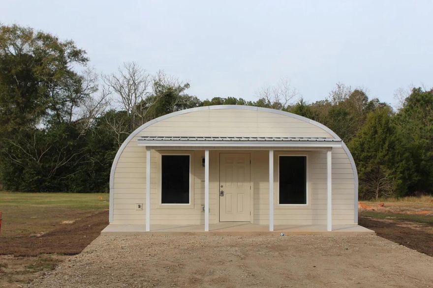 2BR/2BA modern Quonset-style home just a couple minutes from Historic Downtown DeFuniak Springs. Bright open layout with wide-plank hardwood floors, recessed lighting, and a clean, modern kitchen featuring quartz countertops, white shaker cabinets, stainless steel appliances, and a breakfast bar. Home includes a stacked Maytag washer/dryer, two full bathrooms, and comfortable bedroom layouts. Quiet lot with a covered front porch and easy access to shops, dining, festivals, and all downtown events. A truly unique rental that offers both style and an unbeatable location. Schedule your showing today!