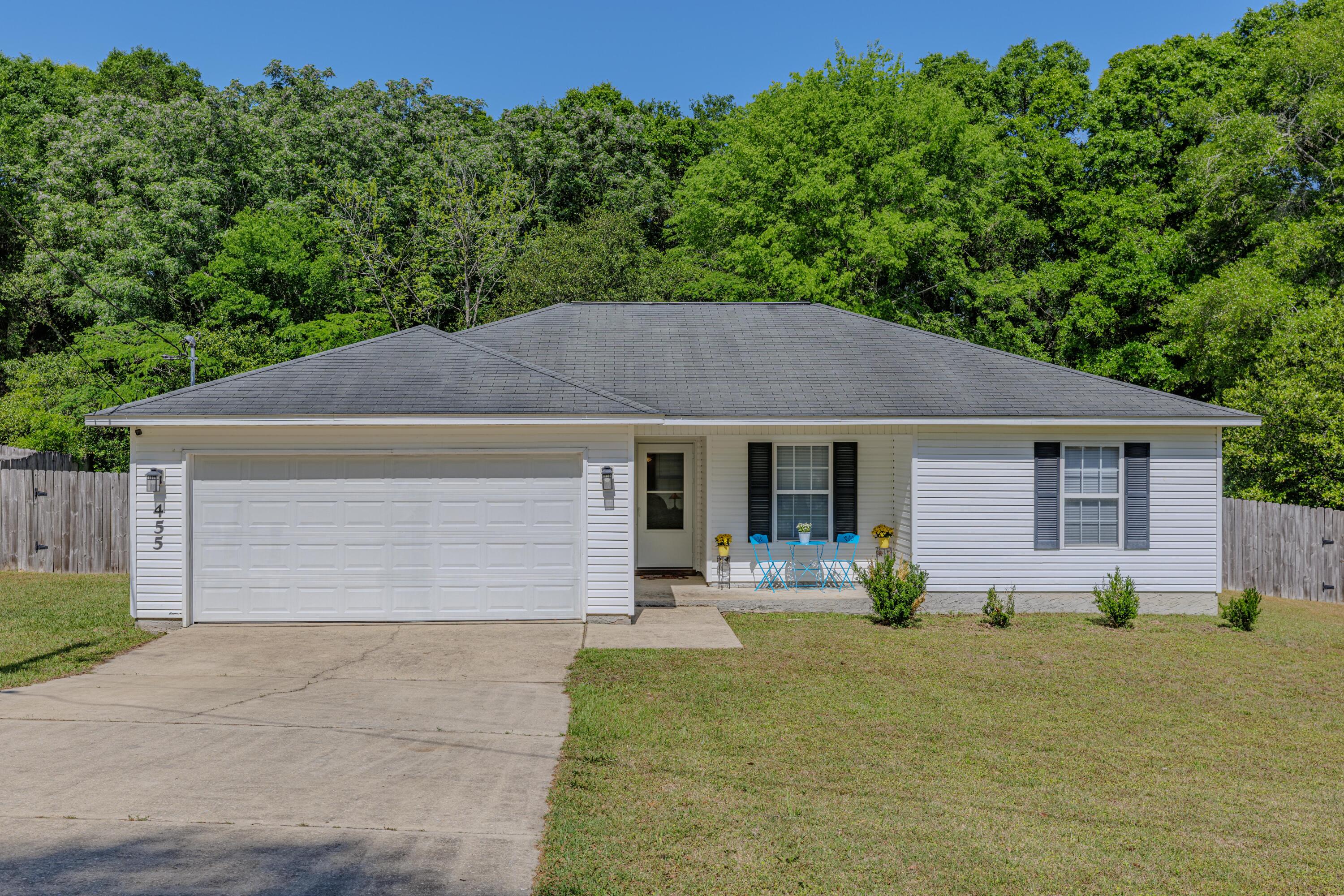This immaculate 3-bedroom, 2-bath ranch-style home strikes the perfect balance between privacy and convenience--just minutes from military bases, shopping, schools, and dining. On a spacious 0.4-acre lot with a serene wooded backdrop and solar panels already installed, you'll enjoy both peace of mind and energy efficiency.Inside, beautiful wood floors flow throughout with tile in all the wet areas. The bright kitchen and cozy breakfast nook offer gorgeous views of the backyard. A split floor plan adds extra privacy, featuring a generous primary suite with a walk-in closet, dual vanities, a jetted tub, and a separate shower. With a dedicated laundry room and a two-car garage, this home truly has it all.
