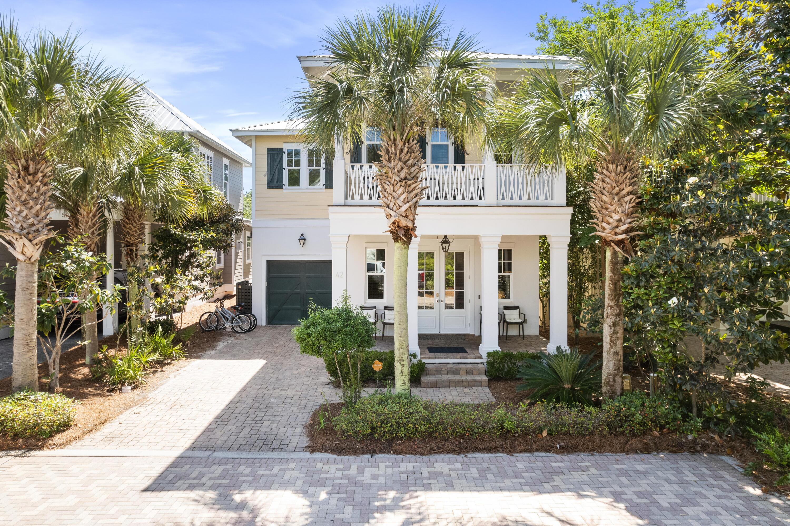 Southern Charm sits on the south side of 30A, between Seaside and Rosemary Beach and is within a short distance to the Gulf of Mexico. This is a quiet cul-de-sac with 11 homes along a brick paver street in the Cottages of Eastern Lake. Step into an open living to dining layout with wood flooring throughout. The dining area can host a large party with additional bar seating from the kitchen. The kitchen is equipped with stainless steel appliances including a Kenmore Elite Refrigerator and Kenmore Pro gas six burner stove top, a large pantry, and granite countertops. There is the Primary Guest Suite on the first level with a spacious bathroom and access to the exterior patio. Both patios have large sitting areas with a wooded view. Head up the stair case with shiplap detailing to the second level where you will find the Bunk Room which includes 3 twin sleeping spaces. Down the hall is a Secondary Guest Suite with private bathroom and access to the exterior porch. The Master Bedroom has ample closet space and storage options with a king bed and sitting area. The Master Bathroom has a walk in shower with glass door, dual vanity areas, and a free standing clawfoot tub to relax after a day in the sun. This home has a one car garage for additional storage needs for beach gear, bikes, and other outdoor equipment. Both exterior porches are screened in and the first level features a gas fireplace. The home is near the walk way to the community pool and a 5 minute walk or quick bike ride to WaterSound West Beach. Both AC units: 2019 and 2022. The home conveys fully furnished with washer and dryer unit and has been meticulously maintained. Short term rentals are permitted and projections are $110K!