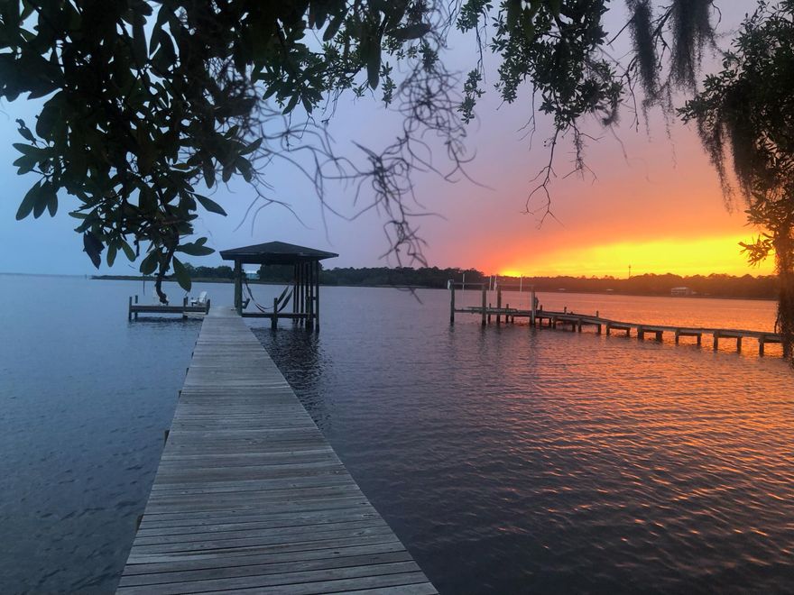 INCREDIBLE VIEWS, from the moment you enter the front door of this RARE waterfront home on George Ellis Point, at the end of LaGrange Road. This 3BR/2BTH all brick home sits on a .6 acre lot on LaGrange Bayou with stunning views going out to the bay and 100 feet of waterfront. Sunsets are breathtaking! A boater's dream, the dock was replaced in 2019 with boat lift, lighting, and a dock swing for dolphin viewing! Metal roof was installed in 2014, the back deck was replaced in 2021 and has under seat lighting. Remodeled kitchen completed in 2021 with new cabinet fronts, lighting, hardware and granite.
