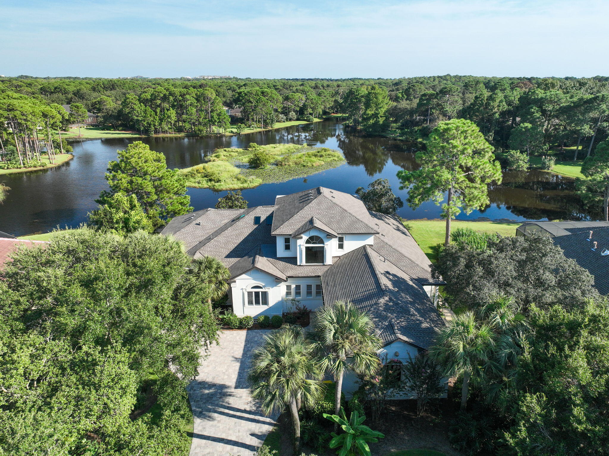 Remodeled Waterfront House with Private Pool, Mother-in-Law Suite & Expansive Living Spaces + NEW ROOF!Welcome to a rare jewel in Destin's most coveted privately gated community -- Kelly Plantation. This exquisitely reimagined 5-bedroom, 4.5-bath + bonus room is a lakefront estate that showcases over 5,100+ square feet of refined living space, masterfully blending modern sophistication with timeless elegance. Completely remodeled to the highest standards, the home offers an open-concept layout designed to maximize natural light, flow, and breathtaking waterfront living from nearly every room. The living room, dining room, and sitting room feature a cozy fireplace and stunning luxury vinyl plank flooring and stunning cathedral ceilings that flows seamlessly throughout the home. Step into a one-of-a-kind, designer-crafted kitchen where timeless elegance meets artisan craftsmanship - all framed by stunning, panoramic lake views that pour in through oversized windows, bathing the space in natural light and serenity.
At the heart of this extraordinary kitchen is an expansive display of Taj Mahal Quartzite - a breathtaking natural stone featuring a soft white backdrop laced with delicate golden inlay. More durable than granite and celebrated for its marble-like, wispy drama, this quartzite crowns the countertops and a grand central island, making an unforgettable statement of refined luxury.
Encircling this masterpiece is a collection of storybook white cabinetry, custom-built with exquisite attention to detail. The cabinetry not only offers impeccable storage but also elevates the entire aesthetic, creating a bright, airy elegance that feels both elevated and inviting.
Adding warmth and artistic flair is a handmade, hand-laid pottery-style tile backsplash - each tile unique, each piece a testament to true craftsmanship. This artisanal element adds depth and texture, perfectly contrasting the sleek lines of the premium stainless-steel appliances and the deep, modern sink that completes the professional-grade functionality of the space.
Designed by a visionary and brought to life by a master craftsman, this kitchen is more than a culinary space - it's an inspired retreat, where luxury materials, thoughtful design, and uninterrupted lake views come together to create a truly unforgettable experience.
The 1st floor master suite is a tranquil retreat featuring elegant tray ceilings, private lanai and pool access, a spa-inspired en-suite bath, a soaking tub, Taylor-made tile shower w/ steamy glass, and a custom walk-in closet. A private mother-in-law suite is thoughtfully located on the first floor, featuring a separate entrance, full kitchen, living room with a cozy fireplace, a spacious bedroom, and a well-appointed private bath - perfect for multigenerational living or long-term guests.
The home boasts soaring 12-foot ceilings on the main level and a showstopping, fully enclosed lakefront pool and hot tub that redefine luxury outdoor living. Over $35,000 was meticulously invested into this private oasis, featuring a newly installed stained pine ceiling that exudes warmth and sophistication, a state-of-the-art breathable enclosure for year-round enjoyment, a redesigned deck, and an upgraded high-efficiency pool heater. Every detail was thoughtfully curated to create a seamless indoor-outdoor retreat, perfectly positioned on the lake - offering a level of elegance, privacy, and craftsmanship that is truly unmatched anywhere else.
Upstairs, you'll find two additional bedrooms, a stylish full bath, and a generous 2nd living area complete with a third kitchen, 10-foot ceilings, and separate washer/dryer hookups - a rare and highly versatile layout offering exceptional comfort and independence for guests...all while overlooking Lake Rangia and staring at an island from your bay windows.
Constructed with ICF (Insulated Concrete Form) technology for superior durability, energy efficiency, and noise reduction, this home also includes a three-car garage and extensive outdoor living areas designed for luxury lakeside living. The private lake behind the home is both filtered and stocked with fish, offering a serene and recreational backdrop.
Over $30,000 was invested in exquisite, custom Brazilian pavers that create a stunning first impression as they gracefully welcome you up the driveway, elegantly encircle the home, 3 car garage, and continue down to the poolside and serene lakeside steps - blending luxury, craftsmanship, and timeless curb appeal.
As a resident of Kelly Plantation, you'll enjoy an unrivaled lifestyle with access to world-class community amenities, including:
An owners' clubhouse
A state-of-the-art fitness center with yoga studio
Tennis and pickleball courts
Basketball and beach volleyball courts
Riding stables, community docks, playgrounds, and scenic walking trails, + so much more!
Set amidst the lush, storied landscape of a former turpentine plantation, Kelly Plantation is also home to the iconic golf course designed by Fred Couples and Gene Bates -a championship course winding through tranquil bayous, waterfront vistas, and towering pines.
This move-in ready masterpiece is the perfect blend of luxury, functionality, and privacy in one of Destin's most desirable addresses.
Experience the pinnacle of coastal living - welcome home to Kelly Plantation.