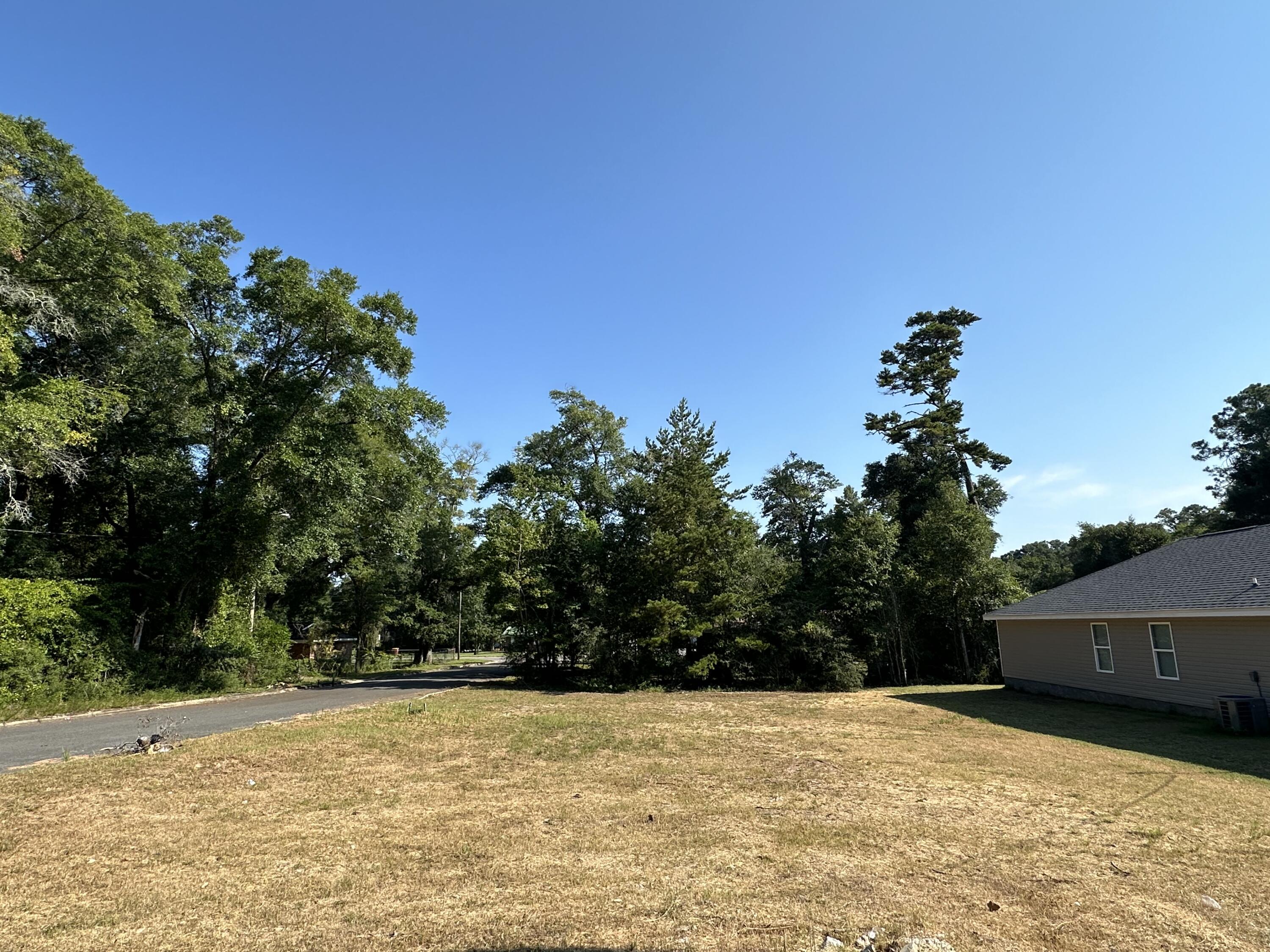 Corner vacant lot. Build a home next door to two other new construction homes. Seller has two lots on W Walnut and willing to package.