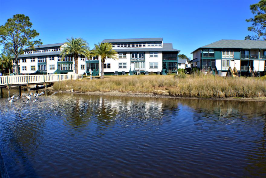 Waterfront condo with a deeded boat slip w/lift on Grand Lagoon! This Greenwood Estates unit has 3BR/2.5BA and lots of recent upgrades including all new stainless steel kitchen appliances, new furnishings which convey, new AC and windows, updated baths, fresh paint, and there is also a new 10,000lbs boat lift. The windows and roof were replaced in the last year thanks to the condo association. Greenwood Estates amenities include a community pool, covered picnic/grilling area, and a gated entry to the boat dock. The boat slip that conveys is #13. You're just 5 minutes from the beach, marinas, restaurants and so much more! Great for long term rentals or as your own vacation getaway! All info is approx. and must be verified by Buyers if important.