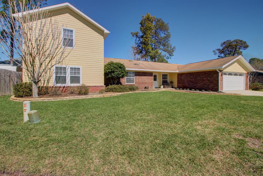 5 Bedroom home in the heart of Niceville in the desirable established neighborhood of Palm Estates! This home has been very well cared for by the current owners over the past 21 years. Originally built in 1978, this lovingly maintained brick and hardi plank home underwent some updating to the exterior siding, flooring, wainscoting, fixtures and hardware in 2009. As you enter this home, an inviting brick hearth (painted) wood burning fireplace is in the center of the living room which has a cathedral ceiling with a decorative pine beam. There is a formal dining room directly off the kitchen which features stainless steel appliances, bead board back splash and freshly painted white cabinetry. Also completed in 2009 is a bi-level addition that flows nicely with the original floor plan.