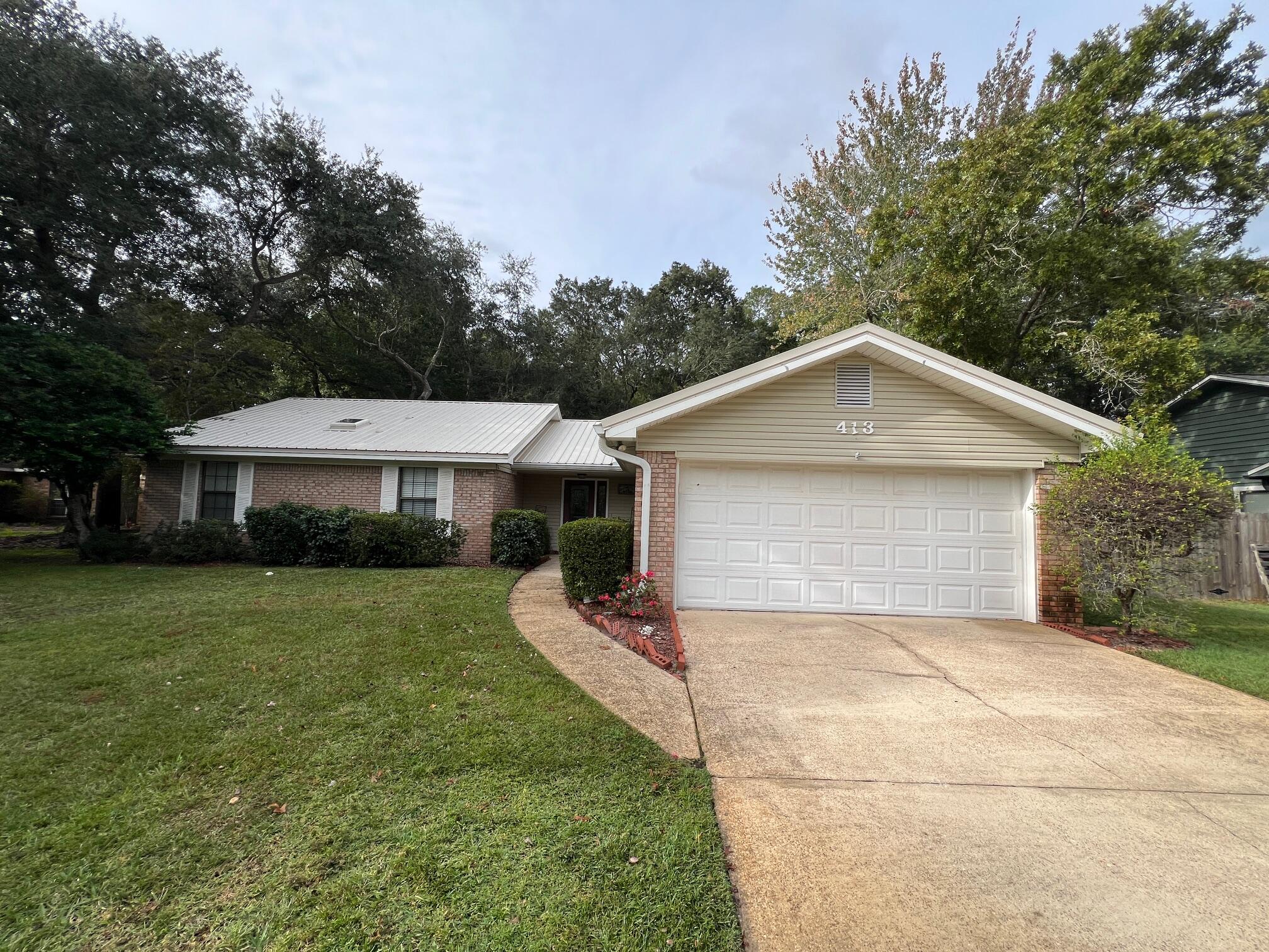 Move-In-Ready! Welcome to this charming 3-Bed, 2-Bath home on a .34 Acre Lot! Conveniently located in Bluewater Bay, close to Beaches, Bases and Shopping! As you step into the spacious living room, you'll be captivated by the vaulted ceilings and a beautiful brick fireplace, creating an inviting space perfect for relaxation or entertaining. The home features high-quality wood and tile flooring throughout--NO CARPET--ensuring a modern, easy-to-maintain living environment. The kitchen has been nicely updated, including high-quality wood cabinets with soft-close, dovetailed drawers, Granite Countertops & Stainless-steel appliances, providing both elegance and functionality. Double-paned windows throughout, enhances energy efficiency and provides plenty of natural light. The cozy breakfast nook overlooks the large Back yard. The Master Suite offers an oasis of comfort with its separate shower, jetted garden tub, large vanity with a seating area, and a water closet. Convenience is key with the laundry area ideally located next to the 8x7 walk-in closet within the Master Suite. Washer and Dryer are included! Step outside to a beautifully landscaped, privacy fenced backyard filled with mature trees and shrubs, ideal for outdoor activities and gatherings. The wooden deck provides the perfect spot for morning coffee or evening relaxation. The storage shed is perfect for yard tools. The Sprinkler system, lawn pump and automated timer makes lawn upkeep much easier! Metal Roof is 2022, HVAC 2018 and hot water heater Dec 2024! For Peace of Mind, there is a Termite Bond in place with Bryan Pest Control. With its blend of comfort, quality, and beautiful outdoor space, this home is sure to capture your heart. Don't miss out on making it yours!
