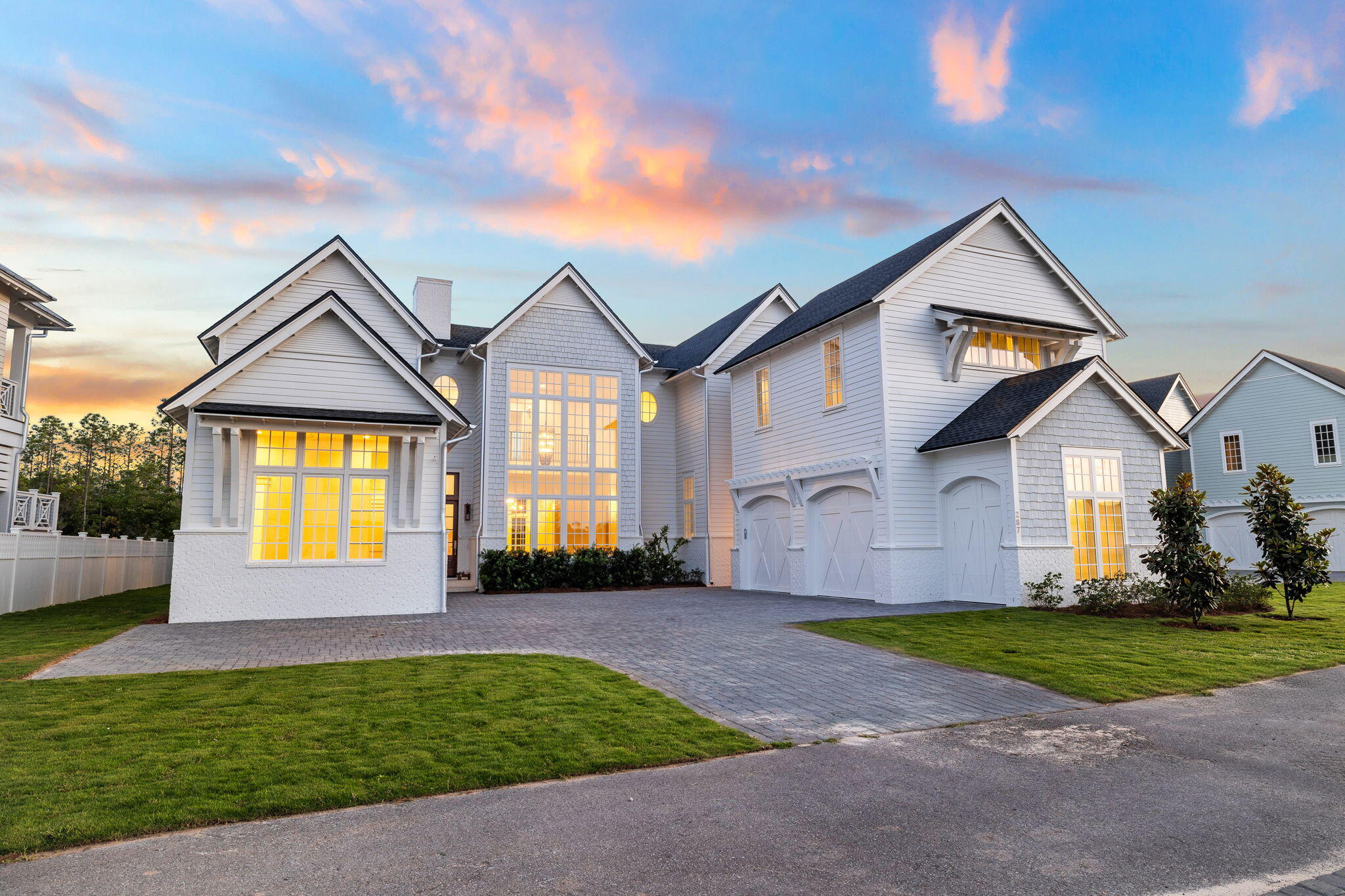 Welcome to your dream home, where the floor plan is designed for the ultimate in entertaining - a true embodiment of Florida living at its finest. This elegant new construction, nestled behind the private gates of Camp Creek, boasts impeccable craftsmanship with a tasteful coastal charm that runs throughout.The first floor features its very own master suite, complete with his and hers walk-in closets and a pristine master bathroom that exudes spa-like vibes. The spacious, open first floor encompasses a gourmet chef's kitchen, a walk-in butler pantry, a wine room, and a living and dining area united by a cozy fireplace.