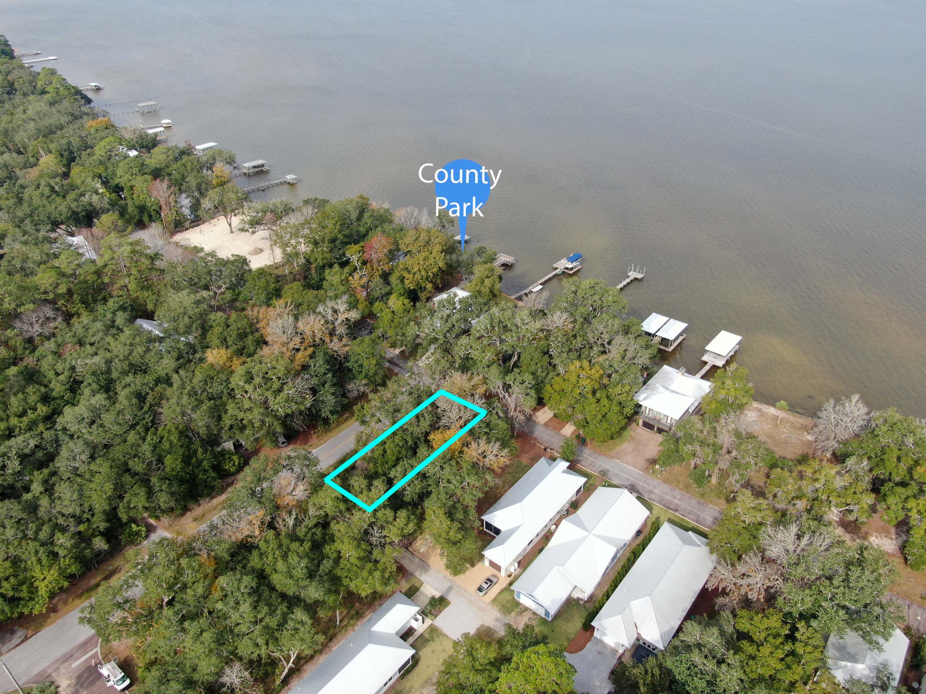This is a great opportunity to build a custom home across from Choctawhatchee Bay among old growth Magnolia and Oak trees on a quiet cul-de-sac in Grayton Bayou. Community amenities include a pool & jacuzzi, public boat launch, and a bayfront dock for fishing, kayak or SUP launch which is conveniently located across the street. This Flood Zone X, 0.16-acre lot is on a corner, with street lights, a private back drive for a garage entry and has potential bay views depending on your design. Minutes from the beaches of 30A, shopping, and dining, it's the perfect location for your dream home by the bay. that South Walton has to offer and is only 15 minutes to the beautiful Gulf beaches.