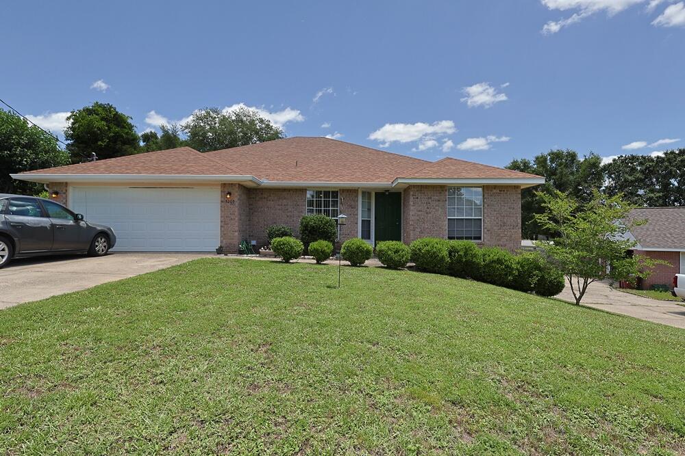 This charming brick home offers 4 bedrooms and 2 bathrooms, featuring a spacious open split floor plan. The living room boasts vaulted ceilings and chair railing, while the kitchen includes a breakfast bar, tiled backsplash, and wood laminate flooring throughout. The home also includes an attached 2-car garage, an indoor laundry room, and a large open deck at the back overlooking a fully fenced backyard. With great potential, this home is ideally located south of Interstate 10, providing easy access to military bases. A newer roof makes insurance a snap. Call today to schedule your showing! Buyer to verify all pertinent information and measurements.