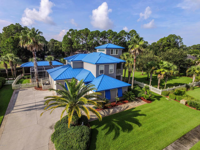 Boaters your oasis awaits you in the gated community of Dolphin Bay! This waterfront, 3-bedroom, 3 bath home is not only equipped with your own private boathouse, but its' location allows you convenient access to our beautiful waterways such as St. Andrew's Bay, the Gulf of Mexico and our intercoastal canals. With Dolphin Bay Marina close by, getting to where you need to go, will never be an issue and you will always have a front row seat to Fourth of July fireworks! In addition to this waterfront haven being the perfect fit for a water lover's lifestyle, the home offers breathtaking water views courtesy of thoughtfully planned out design and a fluid layout that is both peaceful and full of natural light from glass in all the right places. The open and spacious design with little extras