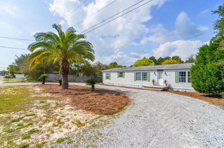 Awesome opportunity to live close to the beach and Lake Powell. This home has many wonderful features such as has a split bedroom plan, open living -dining area and has a brilliant location. This well cared for double wide mobile home is on a large lot 100x128 with plenty of room for all of the water toys and comes with a large fenced in back yard. You will be only a few minutes to the Beach, lake, Pier Park,Carillon Beach and 30A. This is a great investment piece for under $120,000. Check it out before it is too late.