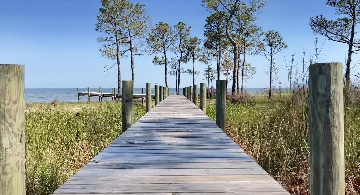 Build the home of your dreams on this lovely waterfront property!! This property is in a gated community and the neighborhood already has underground power, water and sewer. This property provides 80 ft. of waterfront on beautiful sandy beach. There has been 140 foot walkway that has already already been cleared. Come take a look today !!