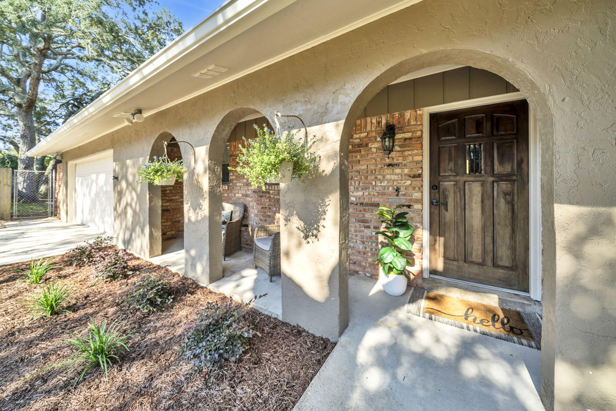 This 3/2 Fort Walton Beach home is right in the middle of it all! One street over from all the shopping and dining available on Mary Esther Cut-Off. Public parks and beaches are just short drive away. Beautiful arches and fresh landscaping greet you as you walk up to this all brick home on a spacious quarter acre lot. The open floor plan is perfect for entertaining. Kitchen has been remodeled with gorgeous granite counters, modern cabinetry, stainless steel appliances and convenient breakfast bar. Off the kitchen there is a generous size sitting area, perfect for a small dining set or coffee bar, along with a pantry with plenty of shelving. The kitchen overlooks the living room and dining room combo area that has a wood burning fireplace and custom built-ins. Large indoor laundry with a dedicated storage room can be found behind the dining area. There are beautiful dark wood floors throughout, save for one bedroom which has brand new carpet. Both bathrooms have been updated. The guest bath features a shower/tub combo with tiles surround and primary en suite has a tiled walk-in shower. The yard is fully privacy fenced and has a good sized slab for lounging and grilling and a large shed. Home has an oversized driveway and 2-car garage. Ewing Ct is a dead-end street with no through traffic. Roof 2021, HVAC 2020, water heater 2014.