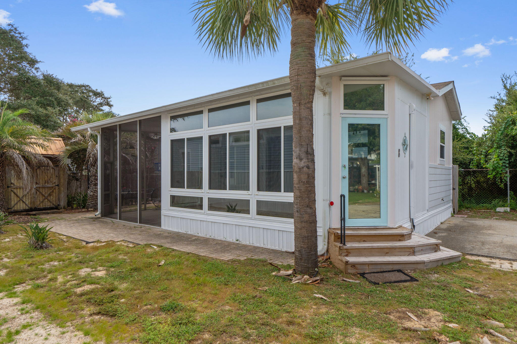 Coastal Cottage living just one block (.22 mi) from the sugar-white sands of Miramar Beach! This 1 Bed, 1 Bath, 940 SF manufactured home is located in Jason Place--a rarely available, gated NON-RENTAL RV/Park Model community of only 14 lots. Situated on a premium back-corner lot for enhanced privacy, the home features 3 efficient Trane split-unit AC systems, wood laminate and tile flooring throughout, custom honeycomb blinds, and a beautifully updated kitchen with stainless steel appliances, including a high-end Samsung refrigerator. The large Florida room offers ideal space for entertaining or relaxing in year-round comfort and flows to a screened porch and open patio. Perfect for a low-maintenance, private beach retreat!
